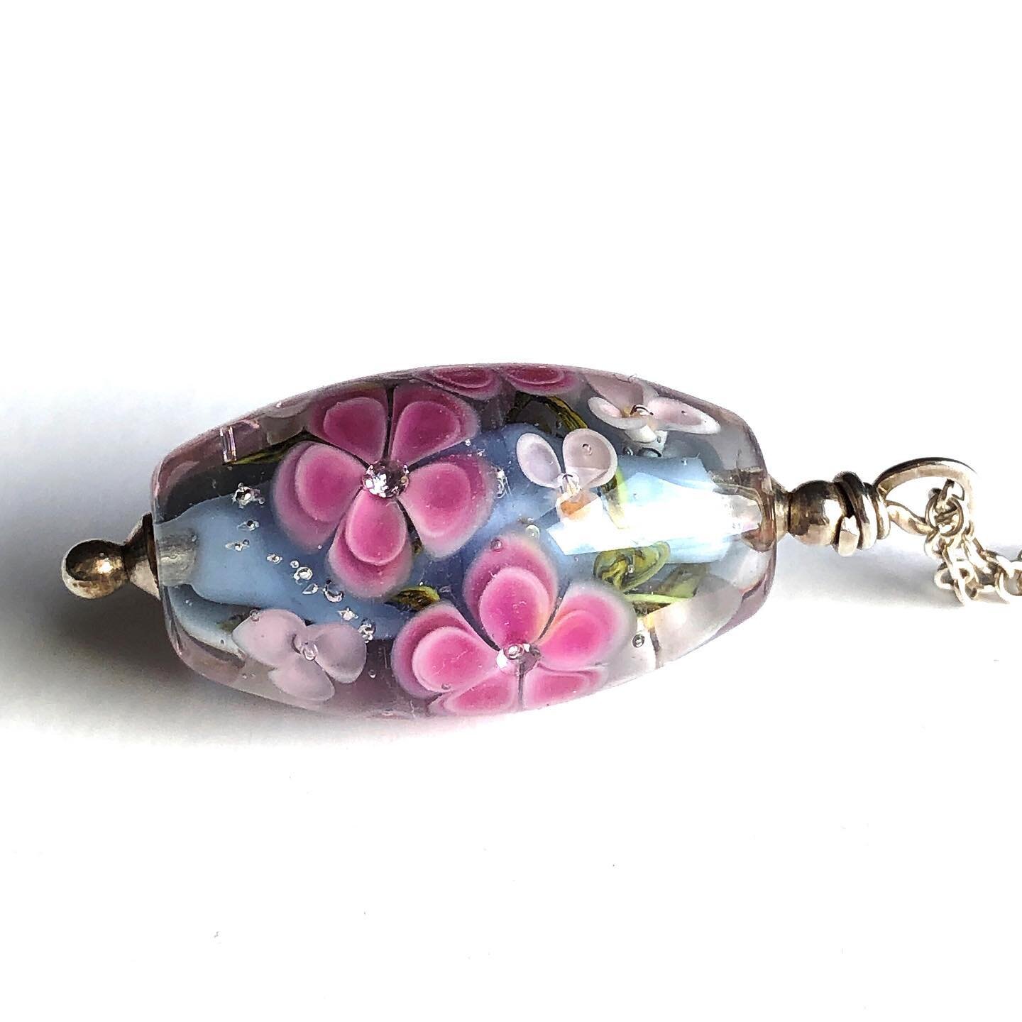 I don&rsquo;t think I have ever posted this one before. This is my necklace, the one I wear every day. I love the pink flowers against this particular shade of blue grey (my favourite!). I love the way the clear glass magnifies the ridiculously spark