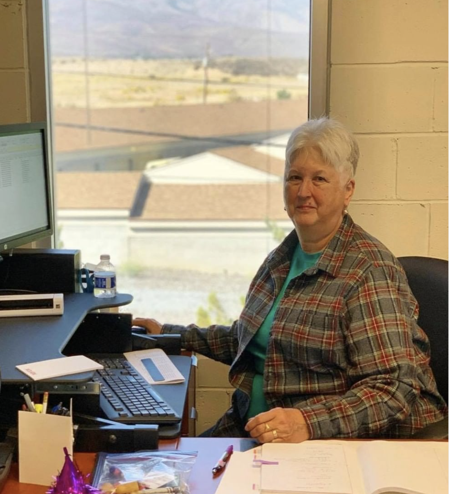 Volunteer Phyllis young at her desk