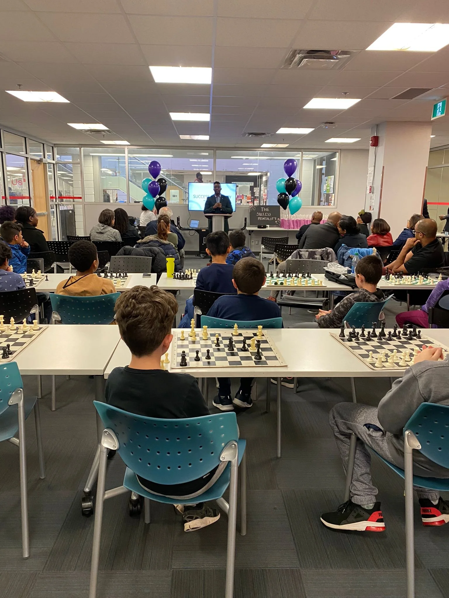 Youth participants playing chess together during an EnRoute 2 Success chess program session