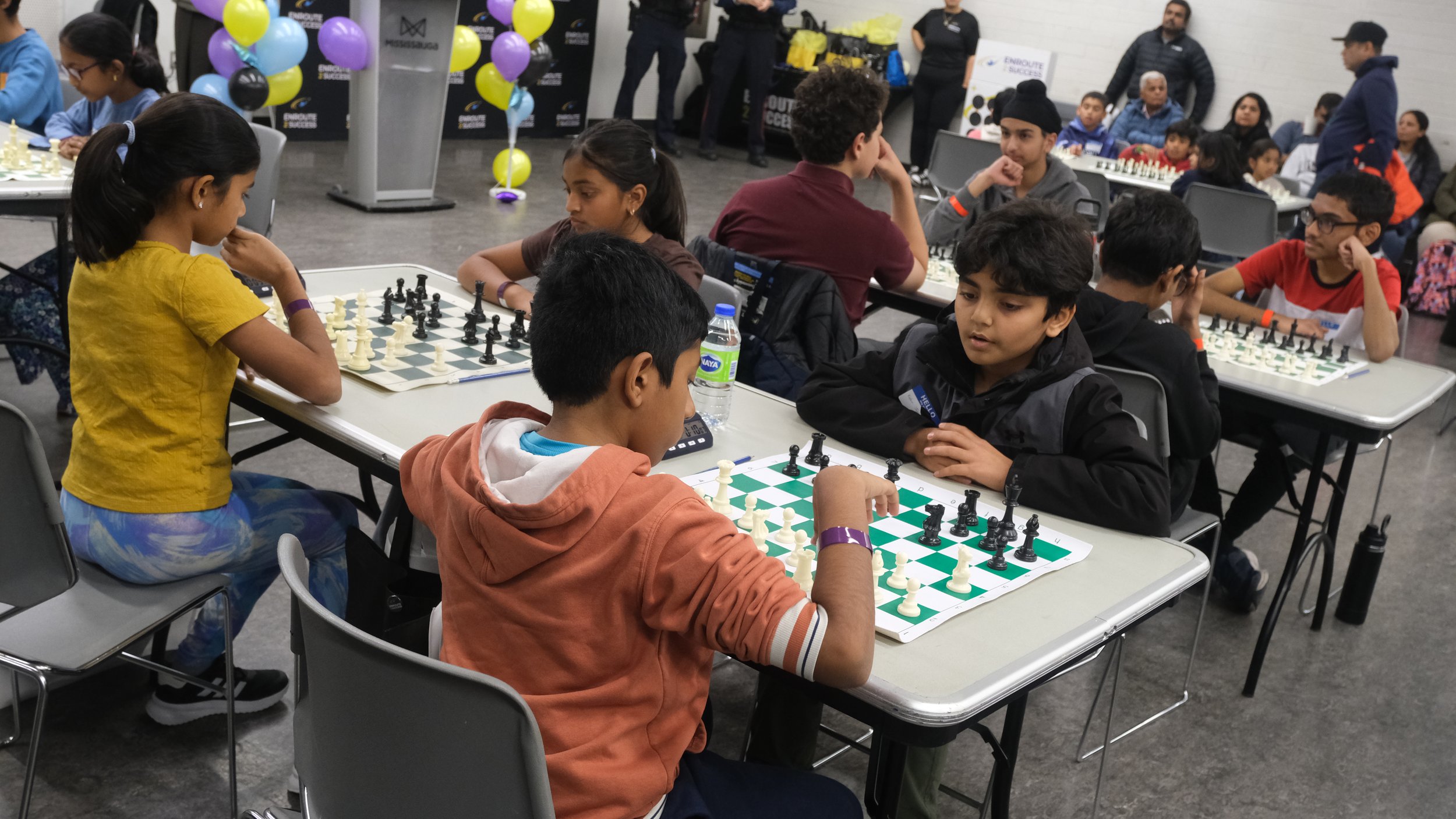 Children competing in a chess tournament during an EnRoute 2 Success community event
