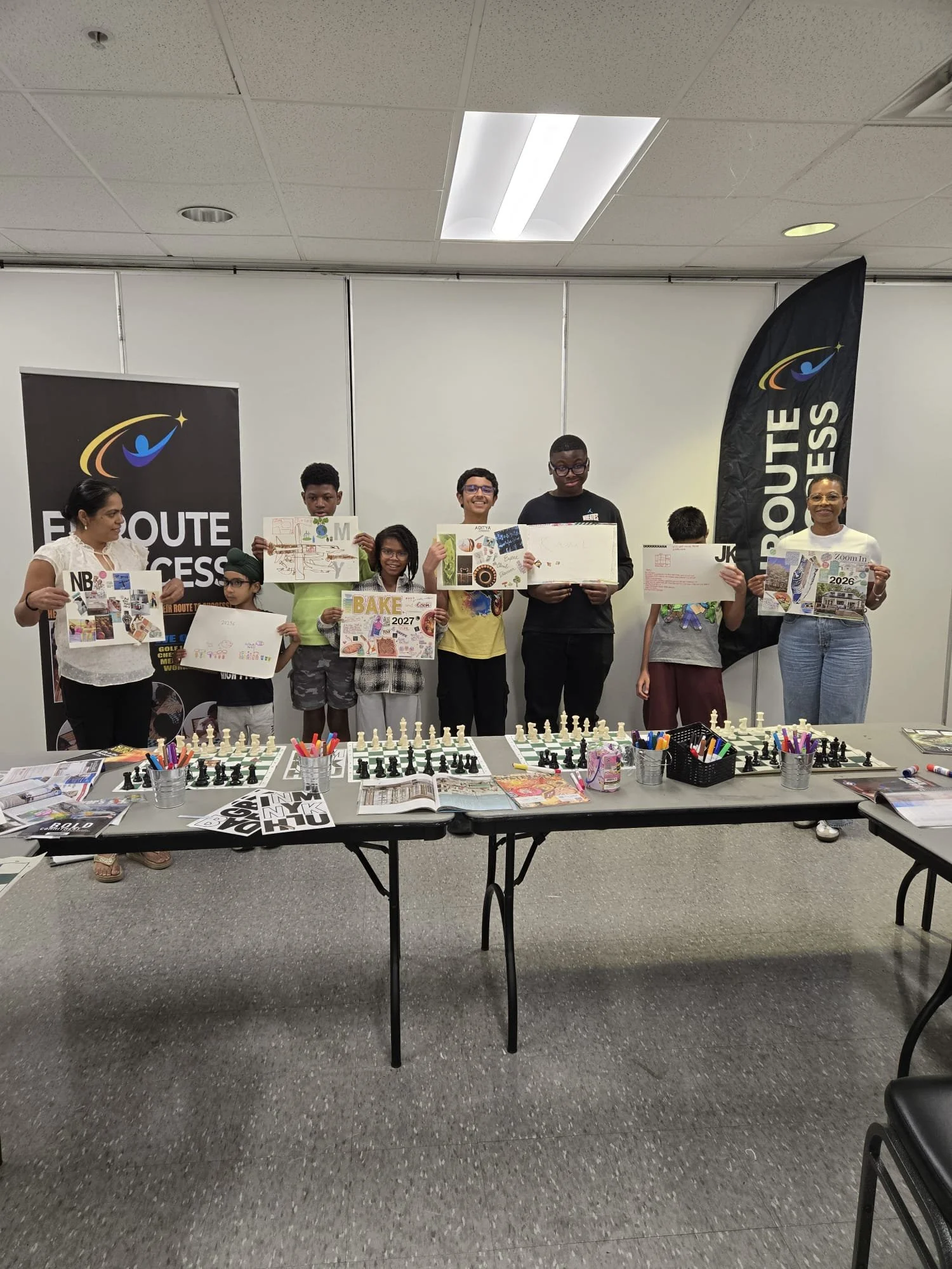 Youth participants holding vision board projects during an EnRoute 2 Success workshop