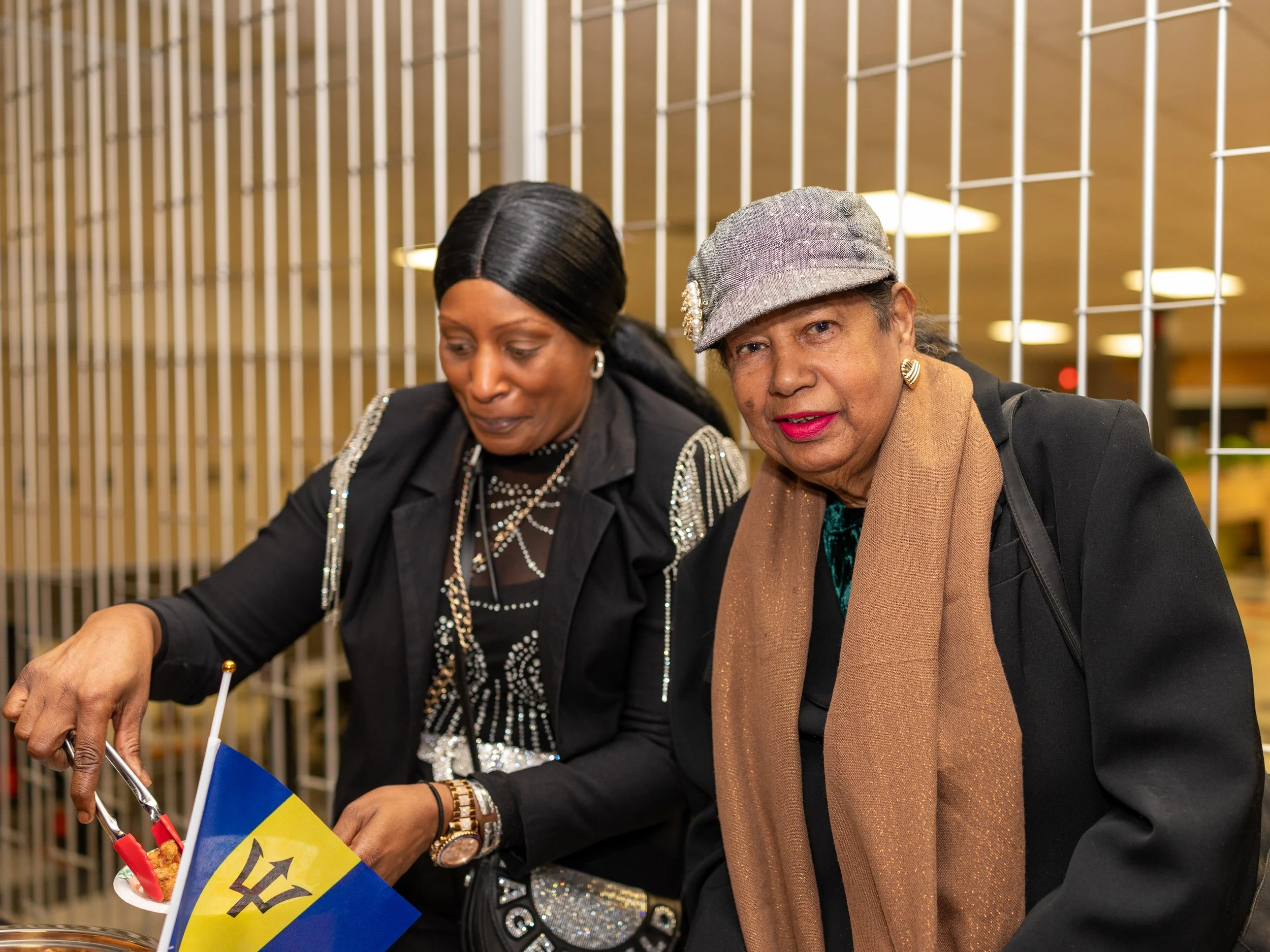 Attendees serving food at reception table after Breaking Barriers theatre event