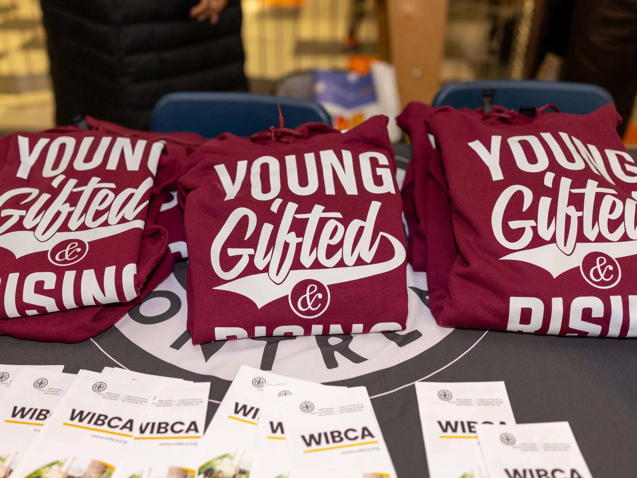 Young Gifted & Rising hoodies displayed with WIBCA brochures during the Breaking Barriers event.