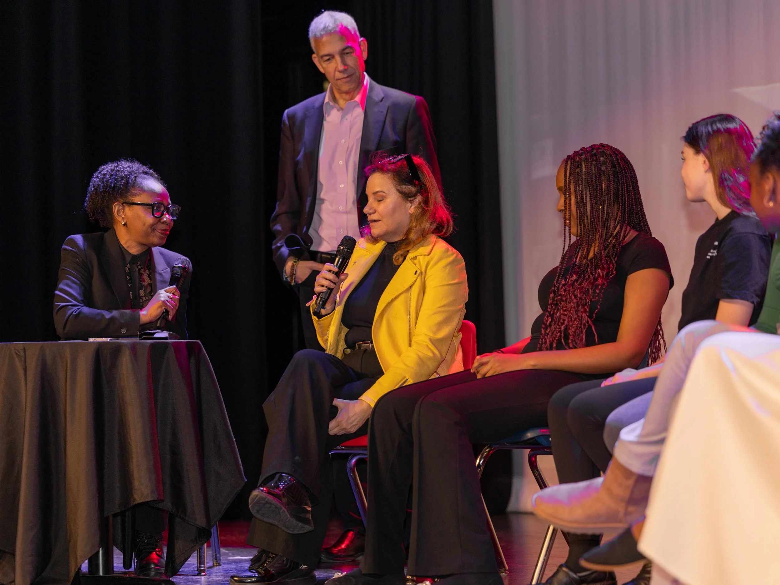 Speaker in yellow jacket sharing remarks during Breaking Barriers: The Story of Gloria Baylis panel discussion