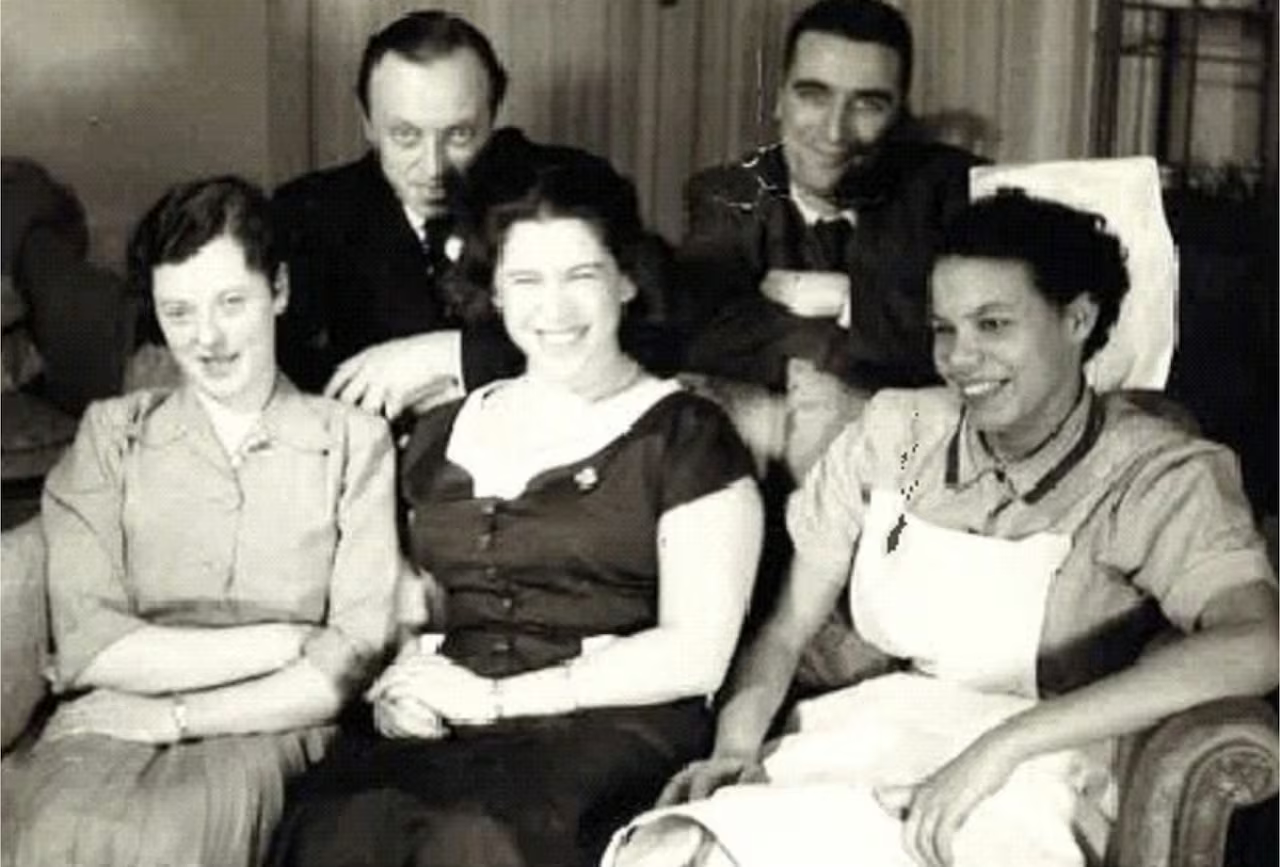 Gloria Baylis seated with colleagues during her early nursing career