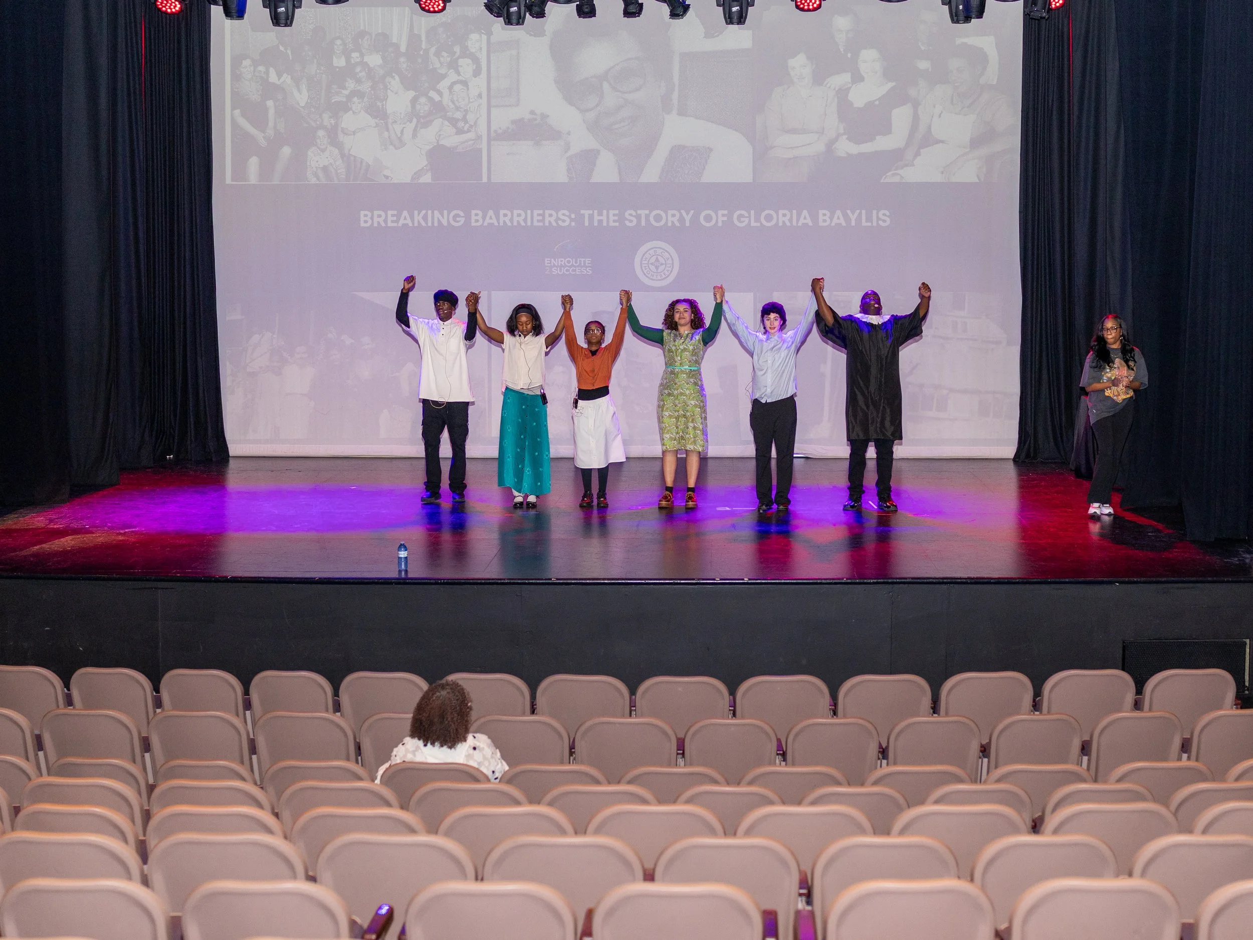 Youth performers take a bow on stage after the Breaking Barriers: The Story of Gloria Baylis theatre production