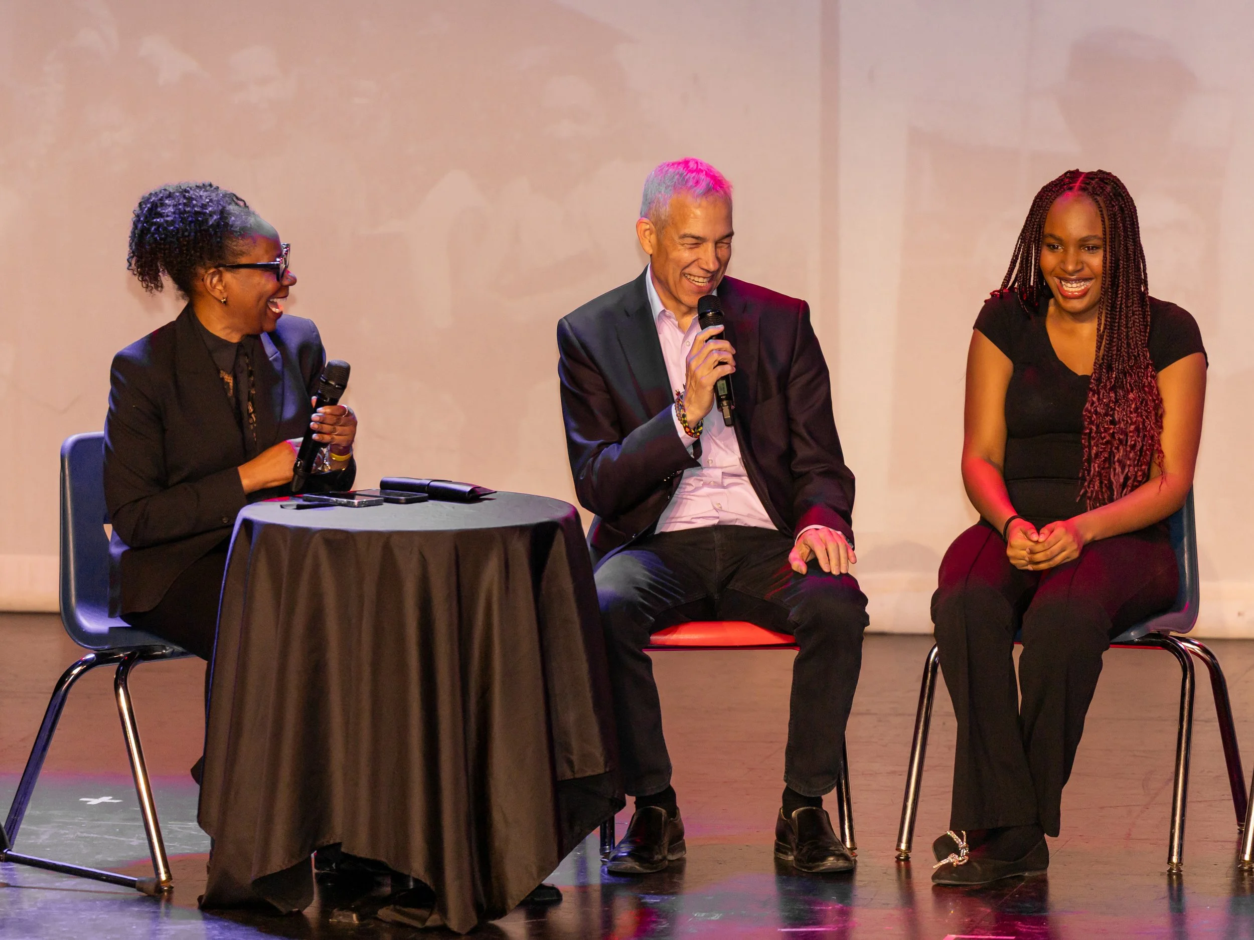 Panelists laughing during live discussion at Breaking Barriers: The Story of Gloria Baylis event