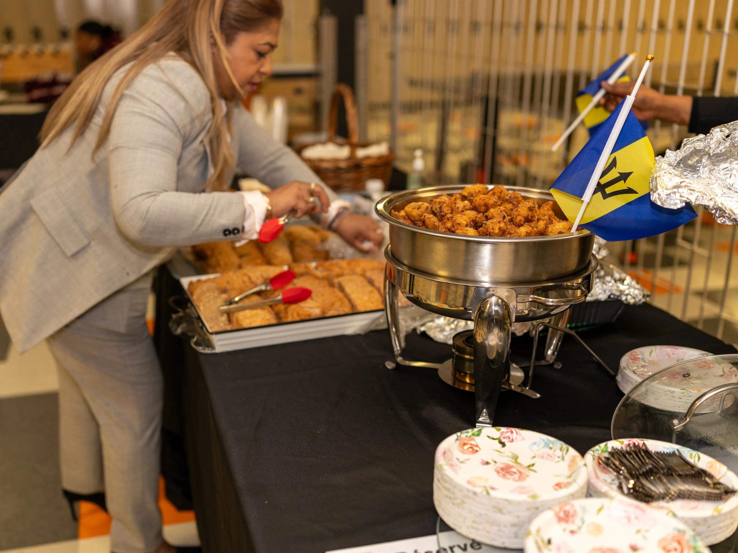 Guests enjoying Caribbean food and refreshments during Breaking Barriers reception