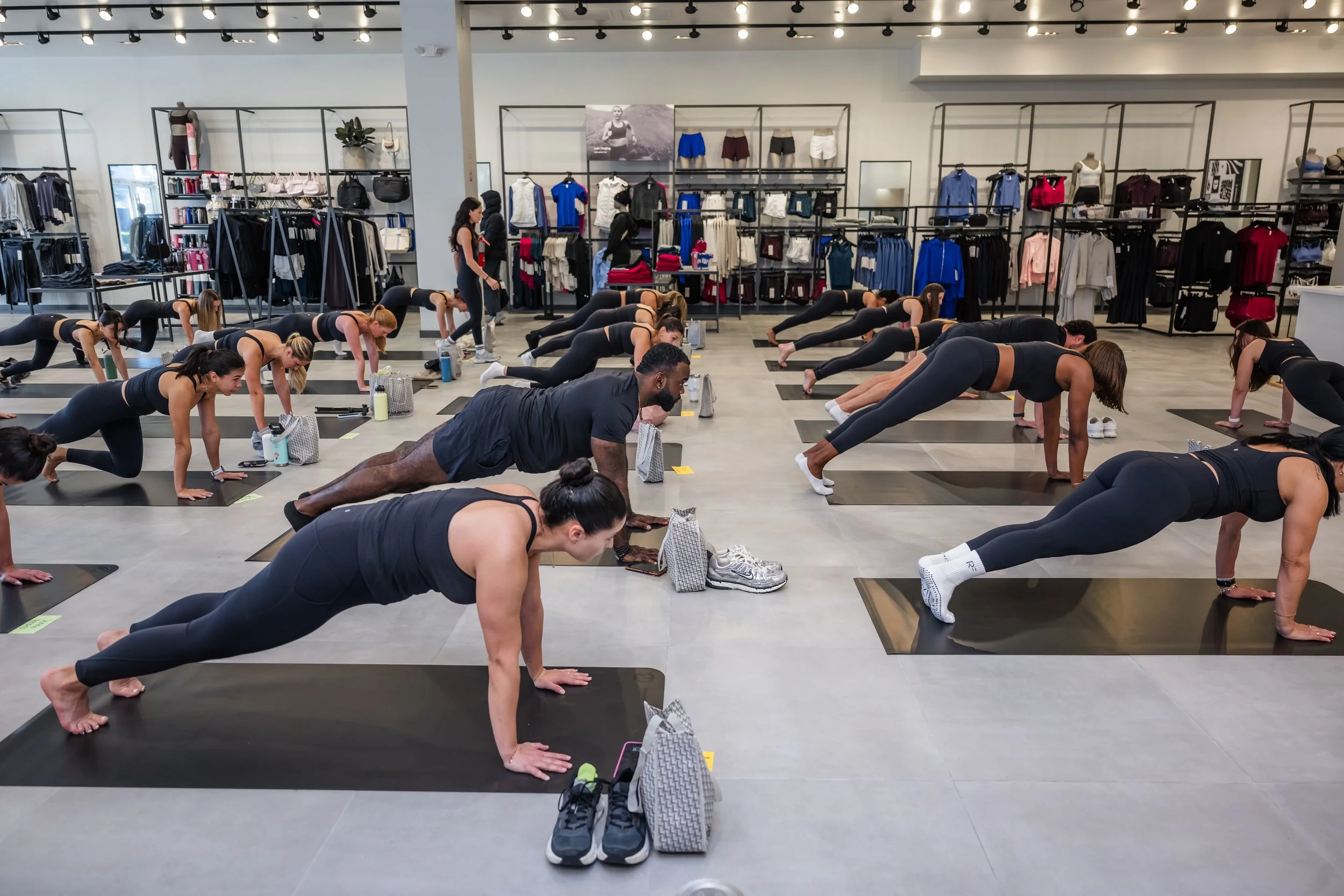 People participating in a group yoga or exercise class inside a retail store.