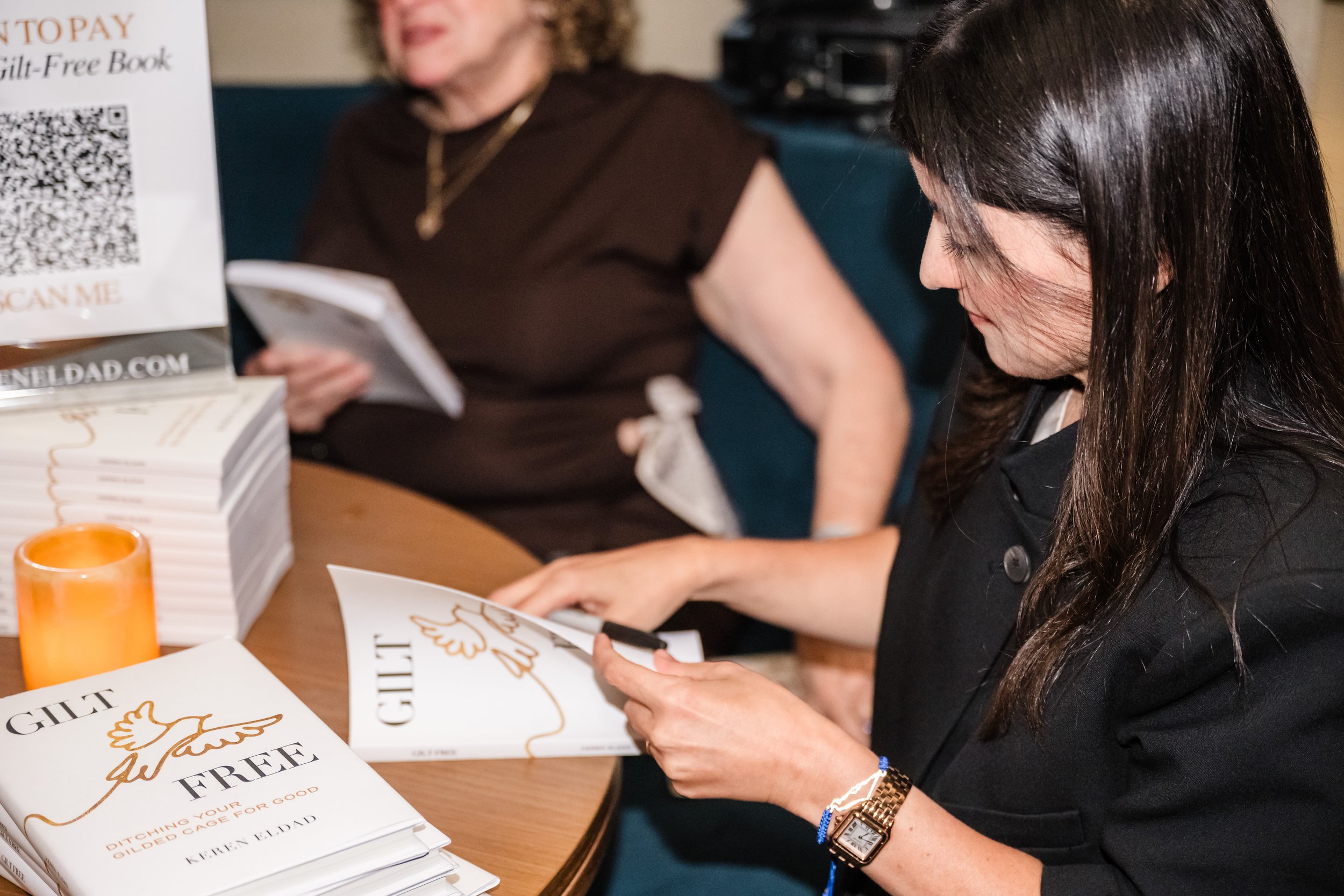 Keren Eldad signs copies of Gilt Free books at the Harbour Club Miami Beach book launch event.