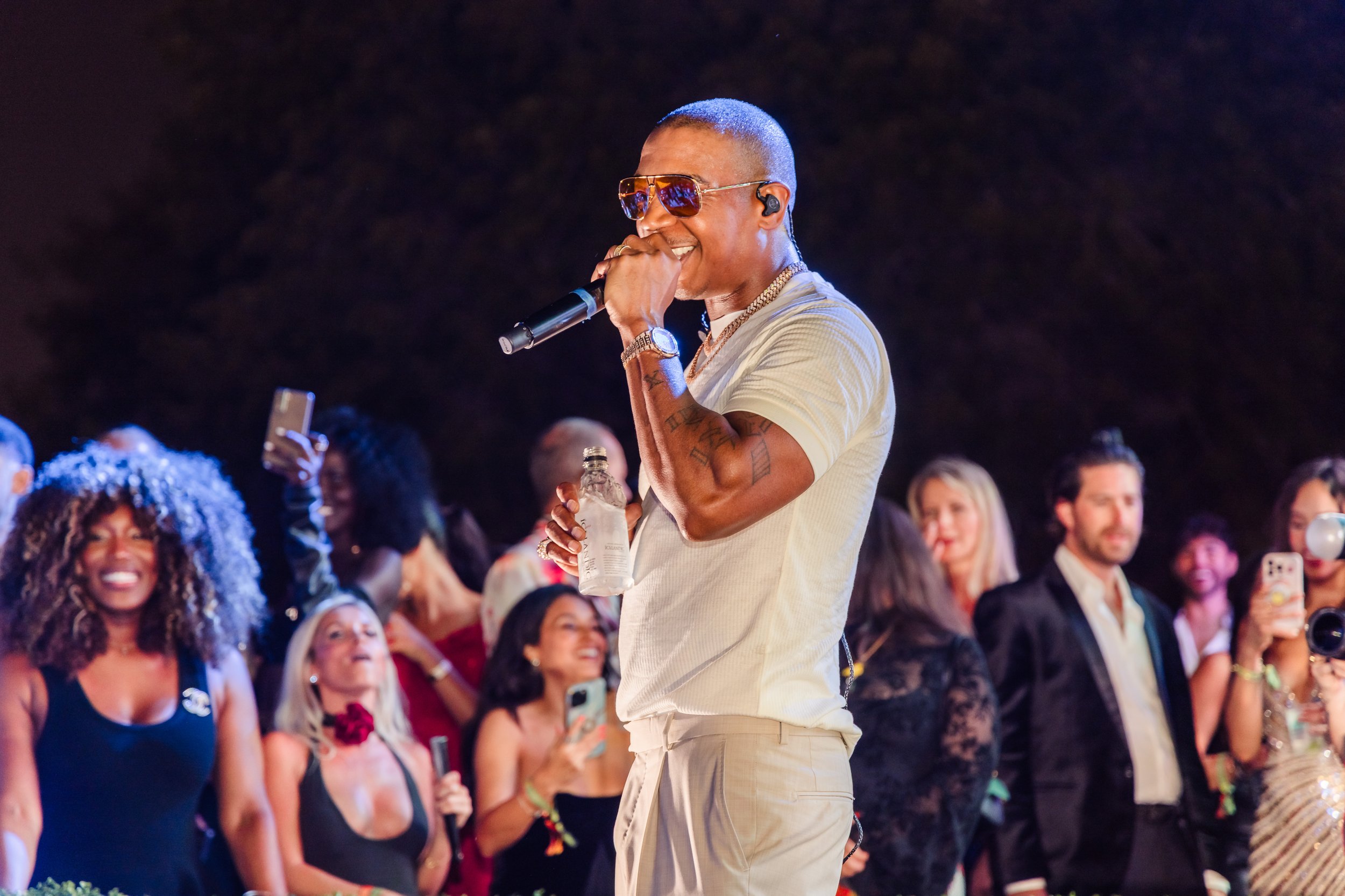 Ja Rule performing with a microphone on stage at the Little Lighthouse Foundation 2025 Hearts and Stars Gala at Jungle Plaza in the Miami Design District with excited guests in the background