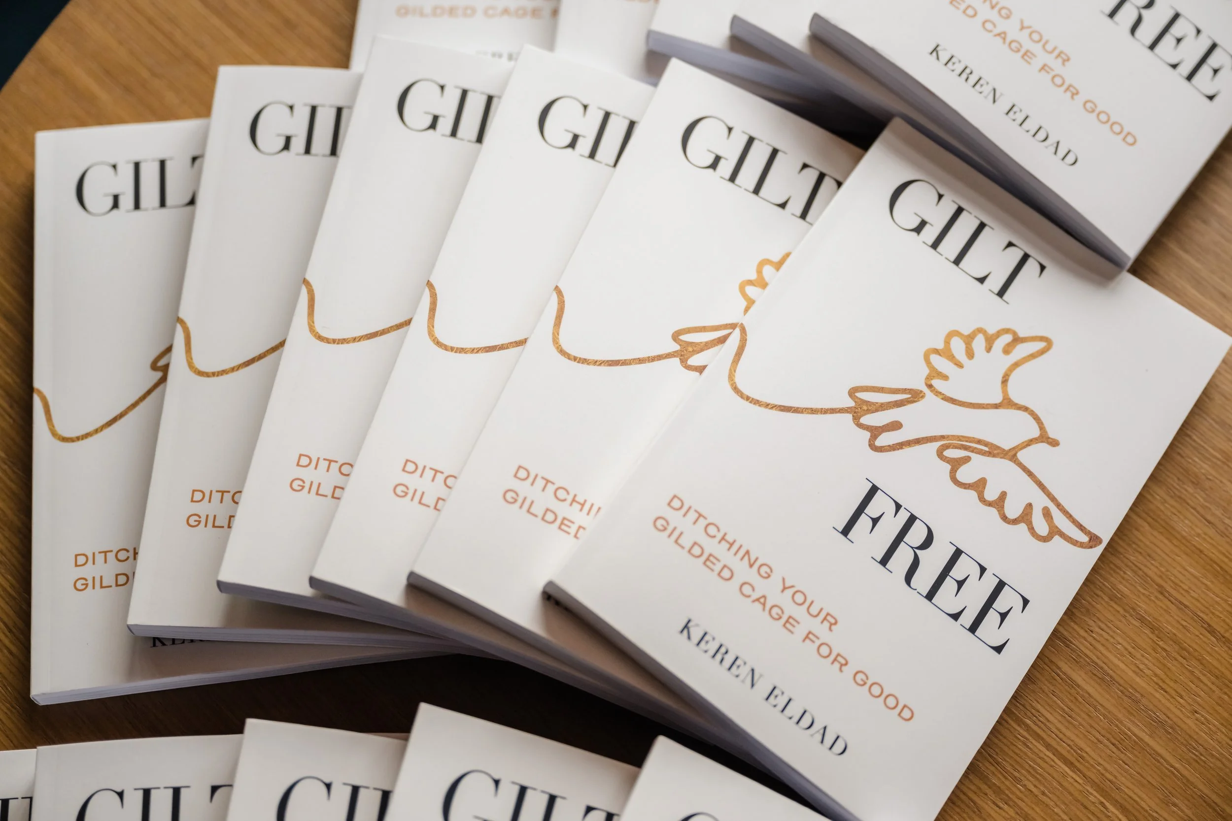 Copies of Keren Eldad’s book Gilt Free: Ditching Your Gilded Cage for Good displayed at a Miami Beach book launch at Harbour Club.