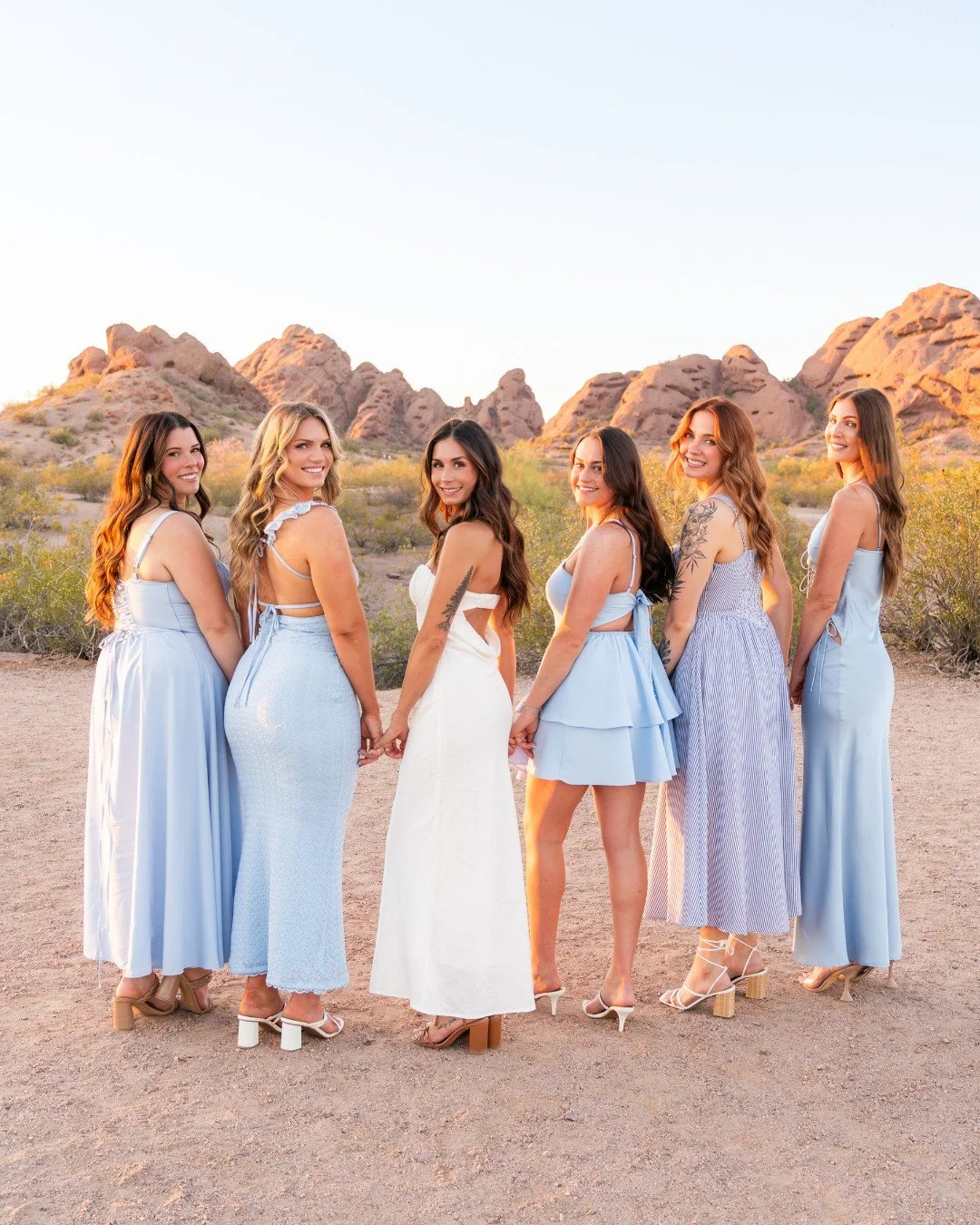 Golden hour, desert views, and the prettiest girl gang in blue. This bridal crew crushed their coordinated looks + made Arizona look even better. 🌵💙🌅⁠
⁠
🌞 Ready to glow like this in the desert? Scottsdale bookings now open for spring &amp; summer