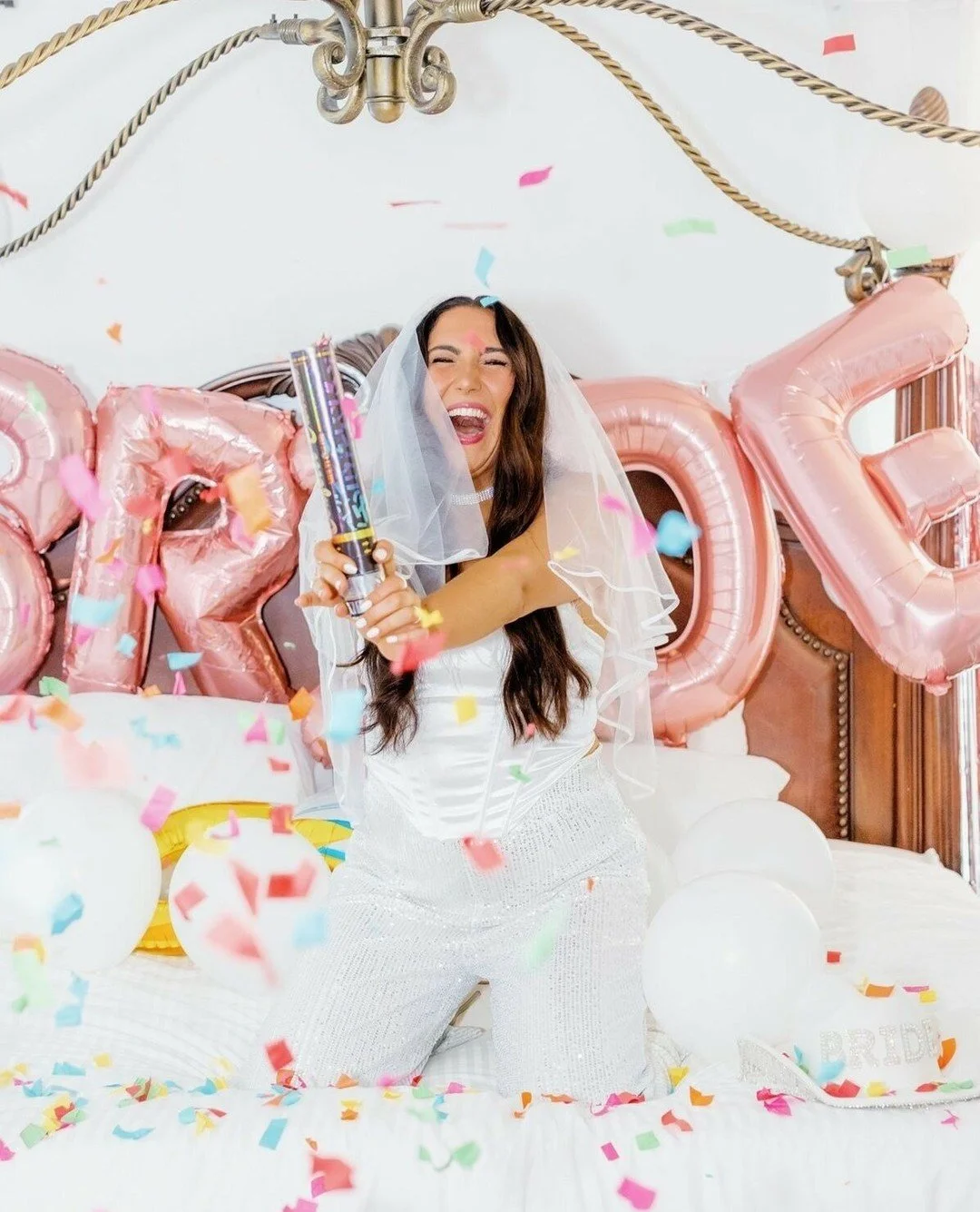 Confetti. Veil. BRIDE balloons. Main character energy activated 💍✨🎉⁠
⁠
This is your sign to say yes to the dramatic champagne pop moment. These are the photos that end up on your save-the-date, your Instagram highlight, your &ldquo;one year married