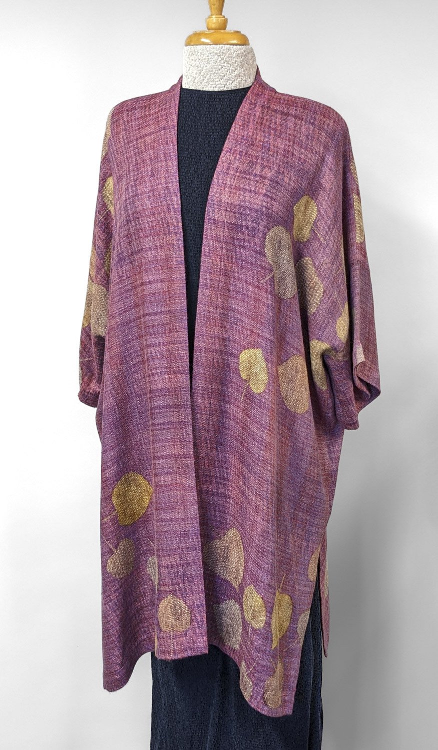 Pink and purple patterned kimono style long tunic with gold leaf designs displayed on a mannequin.