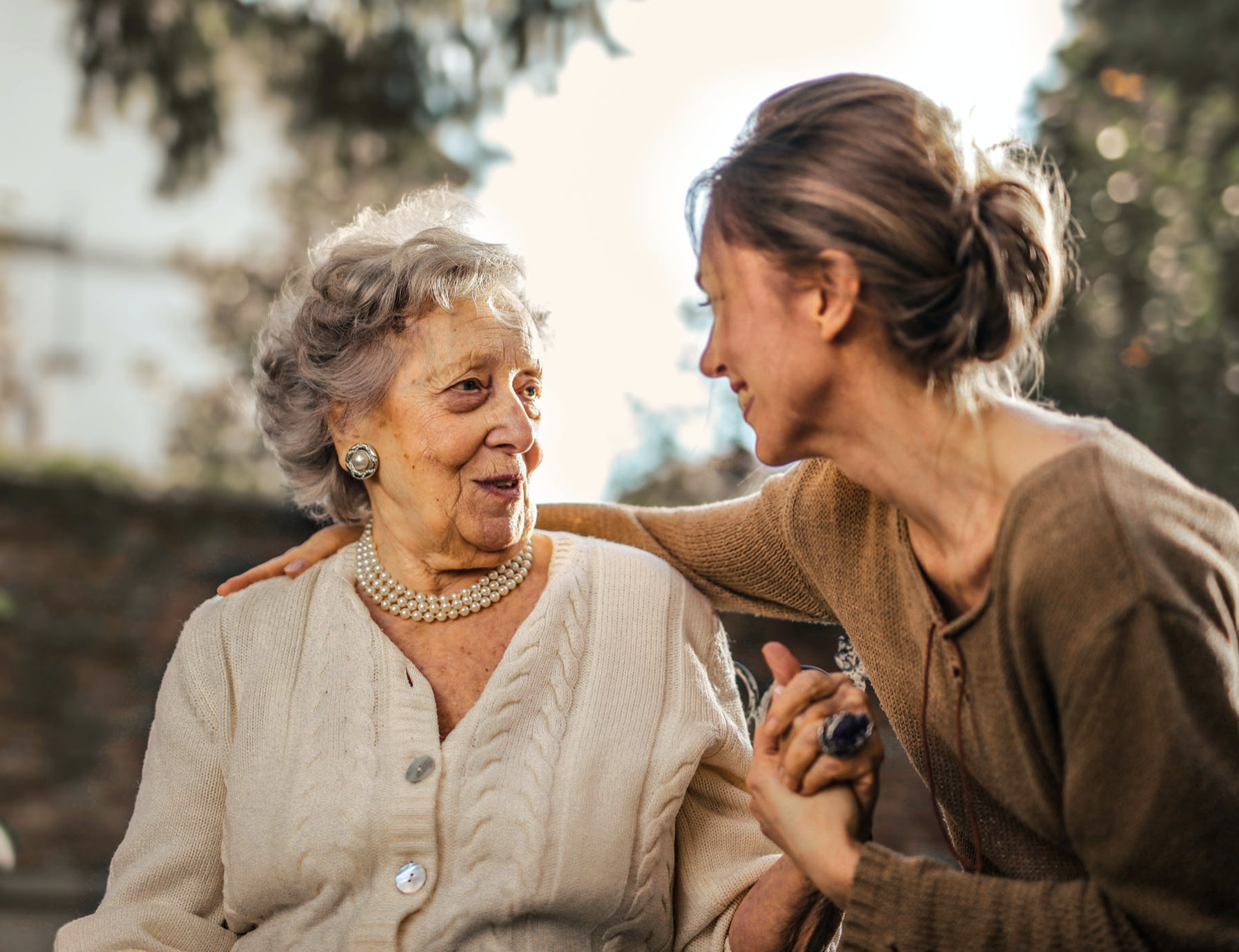 Elderly woman receiving compassionate care and emotional support from a caregiver, representing Mobrise Health's dedication to enhancing senior healthcare solutions.