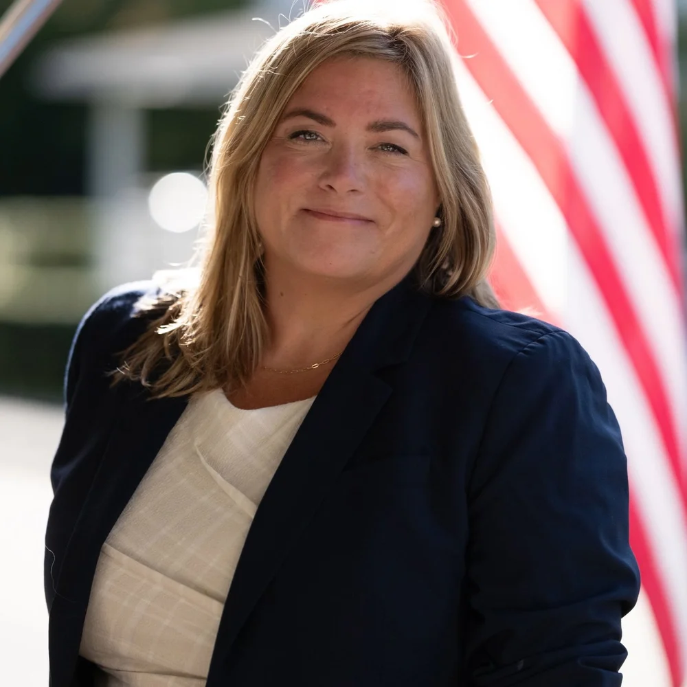Representative Kristin Kassner in front of an American flag