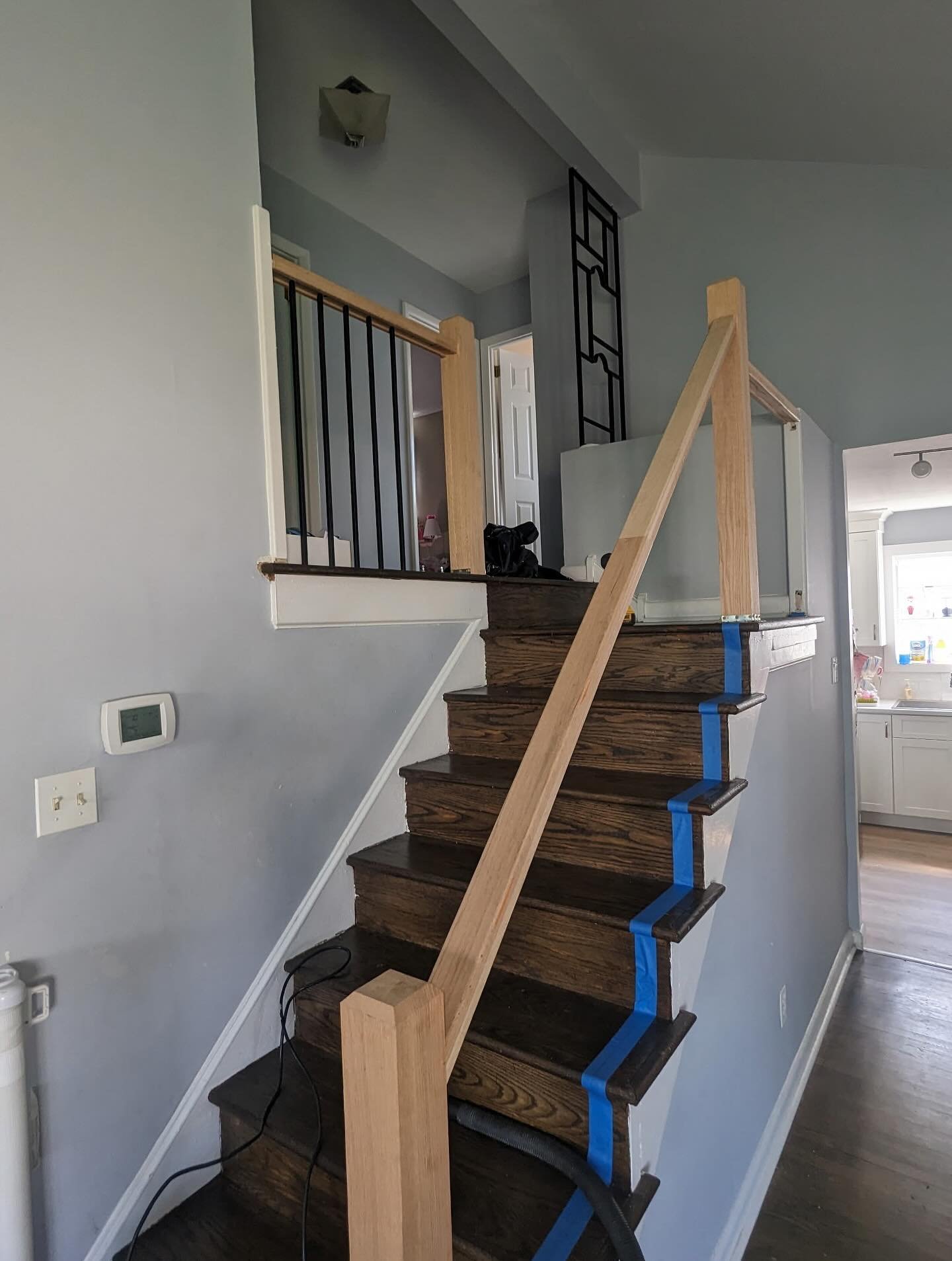 We just finished up replacing a banister in this Havertown home. The previous railing was an iron, outdoor style one (sorry no before pics!). We removed that and added a custom wood banister &amp; black balusters and stained it to match the hardwood 