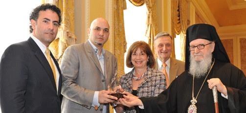 Archbishop Demetrios, Leadership 100 Partner Chairman Michael Bapis (far left) and Dr. Maria Caras present Archbishop Iakovos Leadership 100 Award for Achievement to Michael Psilakis