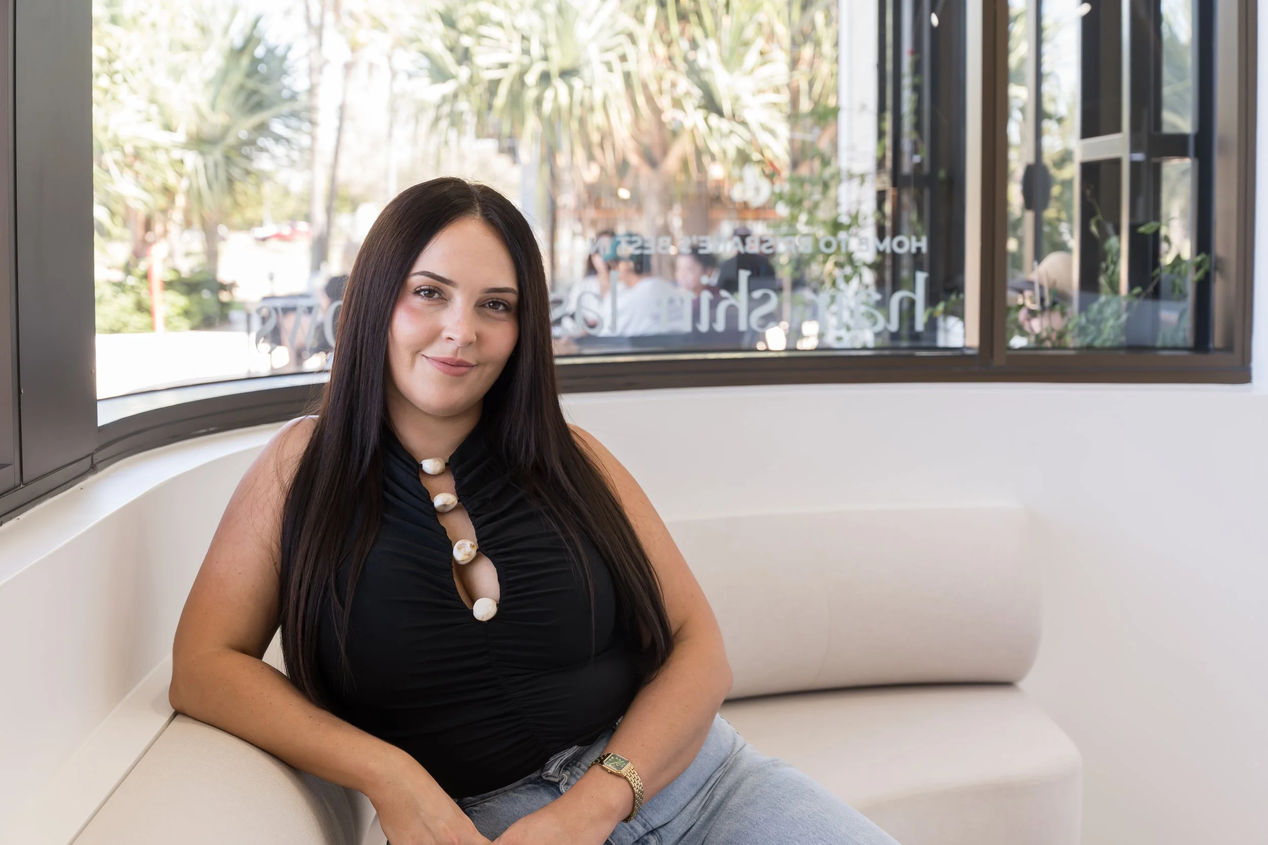 Image of Director Katherine standing by salon reception desk