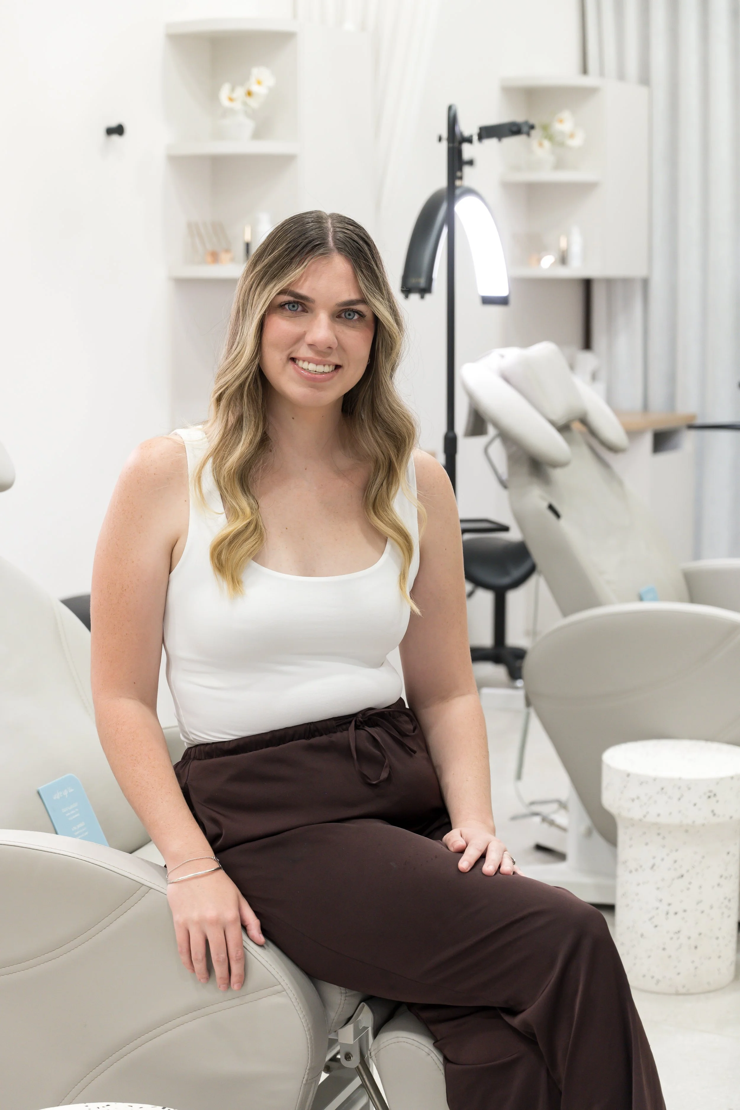Image of Chloe sitting at lash and brow station 