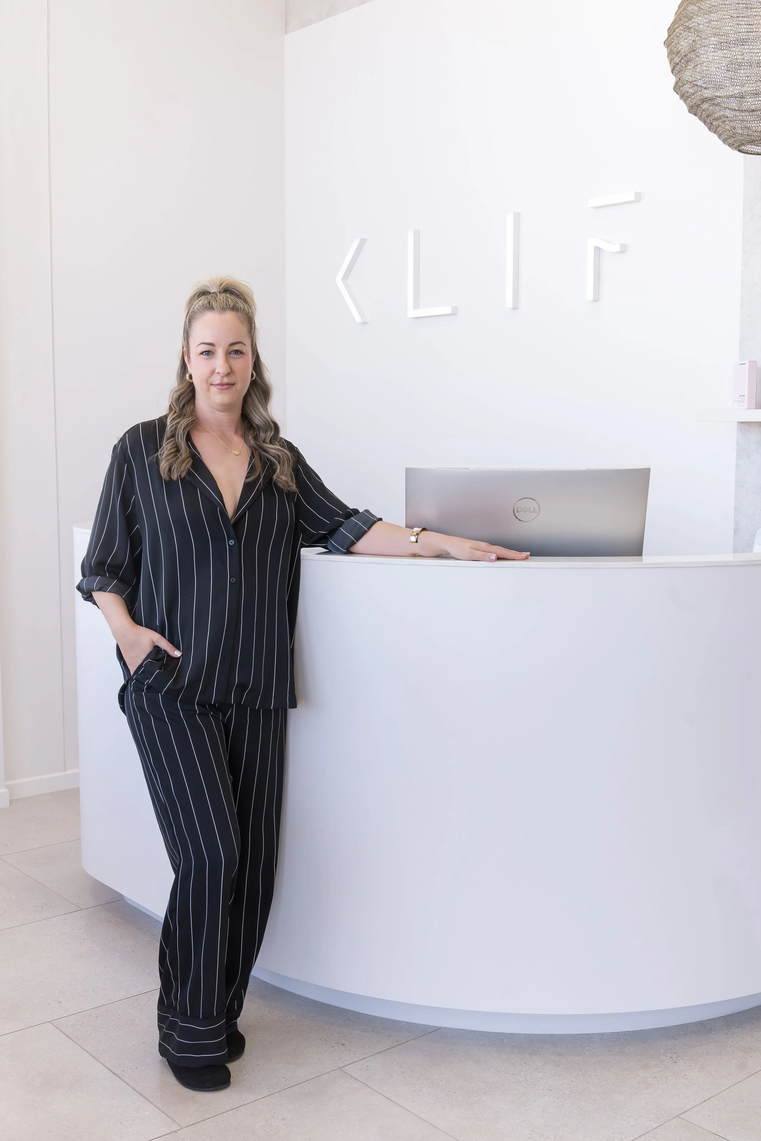 Casey Standing in front of KLIF Newport reception desk 