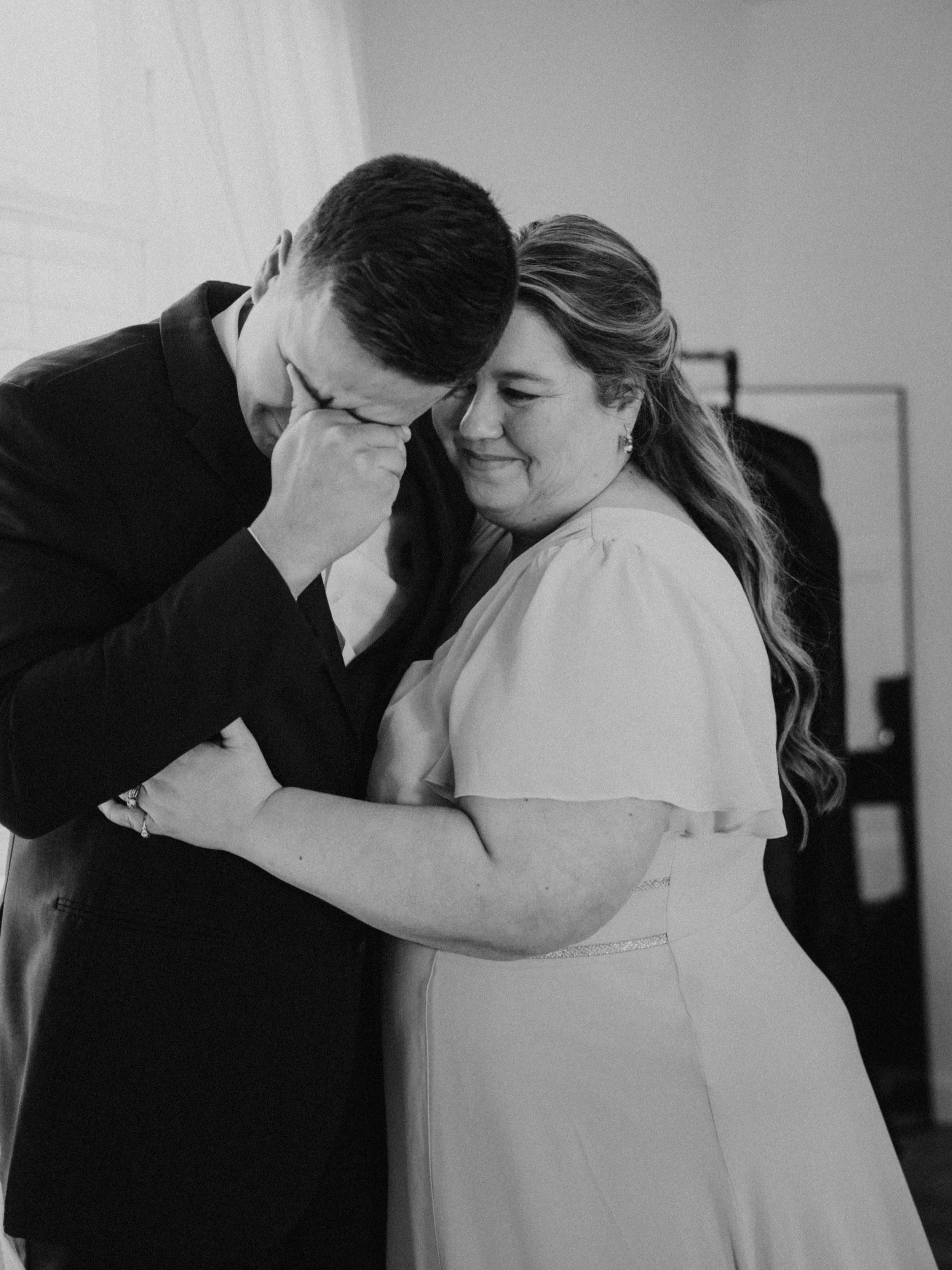 groom cries on wedding day with mom springfield missouri wedding photographer sparrow lane venue