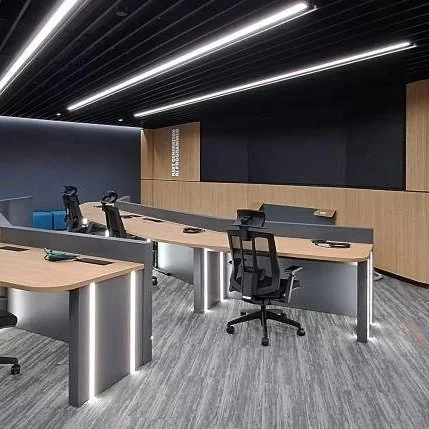 Modern technology workspace interior with integrated desks, ergonomic chairs and presentation screen in Singapore
