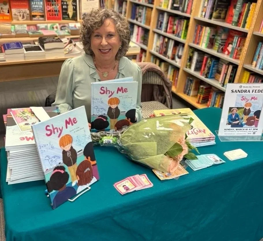 Sandra V. Feder smiling at a book signing in San Francisco