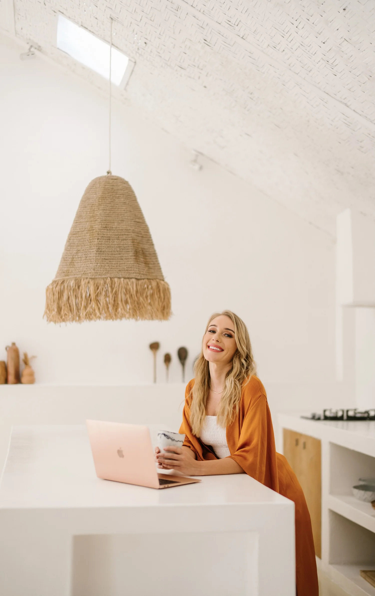 Zoey smiling while seated at her laptop