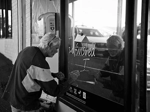 Joe Sykes signwriting action at Unfinished Songs and Pictures exhibition, Mirror Field Narooma