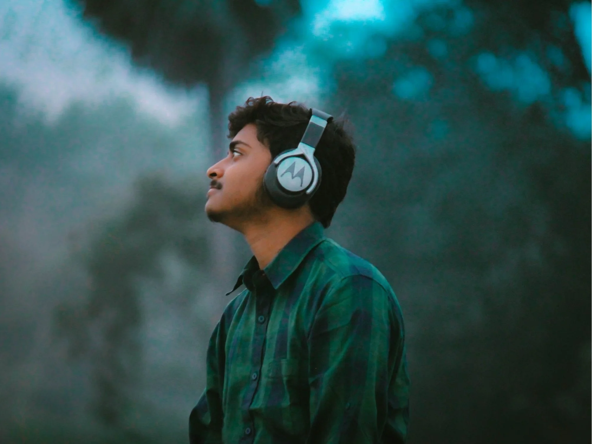 An image of a man listening to a meditation on headphones.