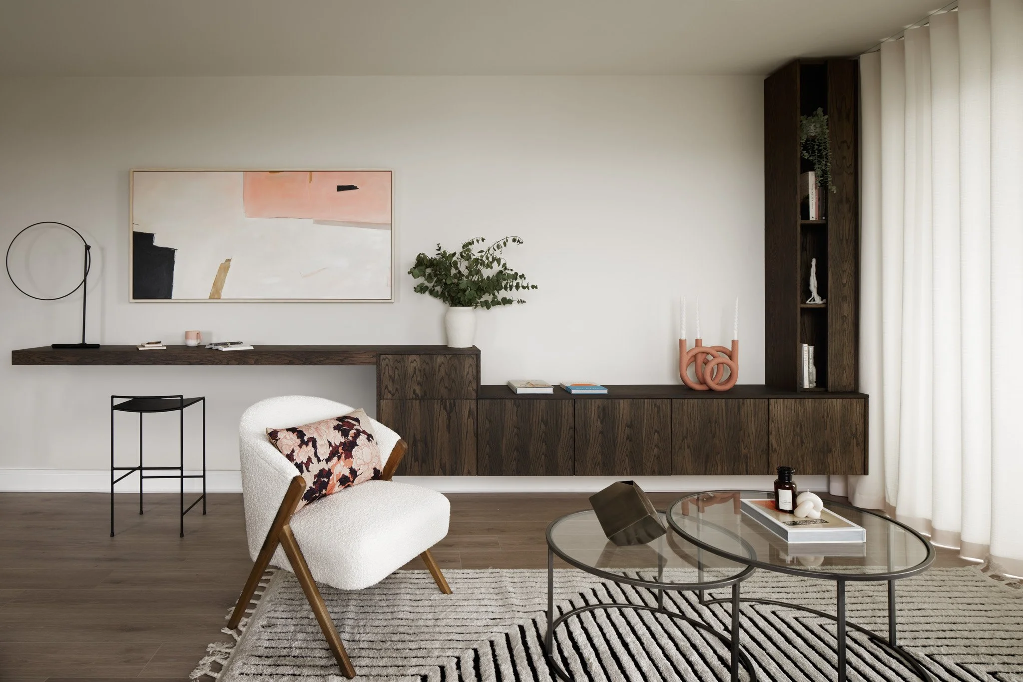 open plan cream interior design with artwork on wall and custom cabinetry