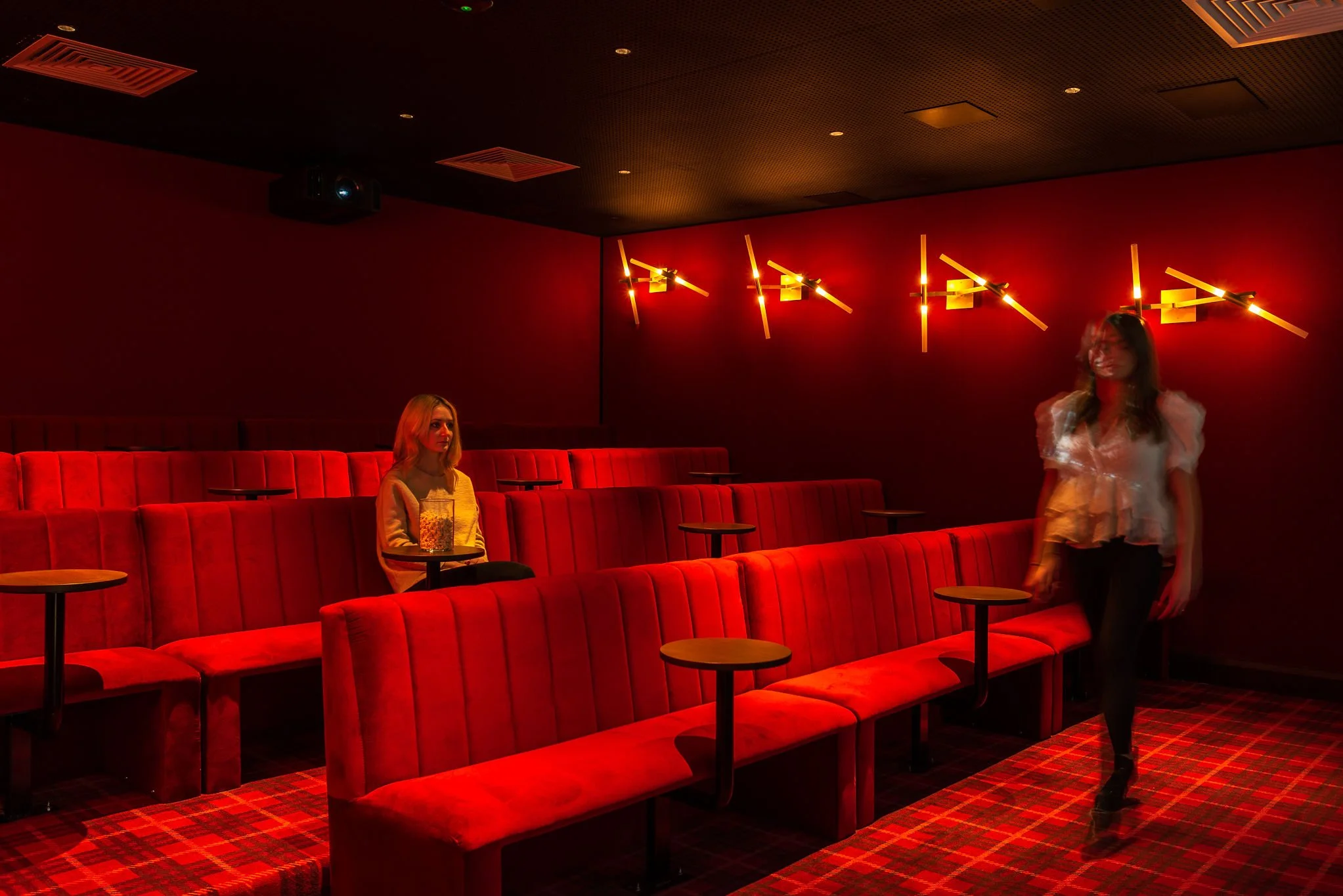 red home cinema with people watching