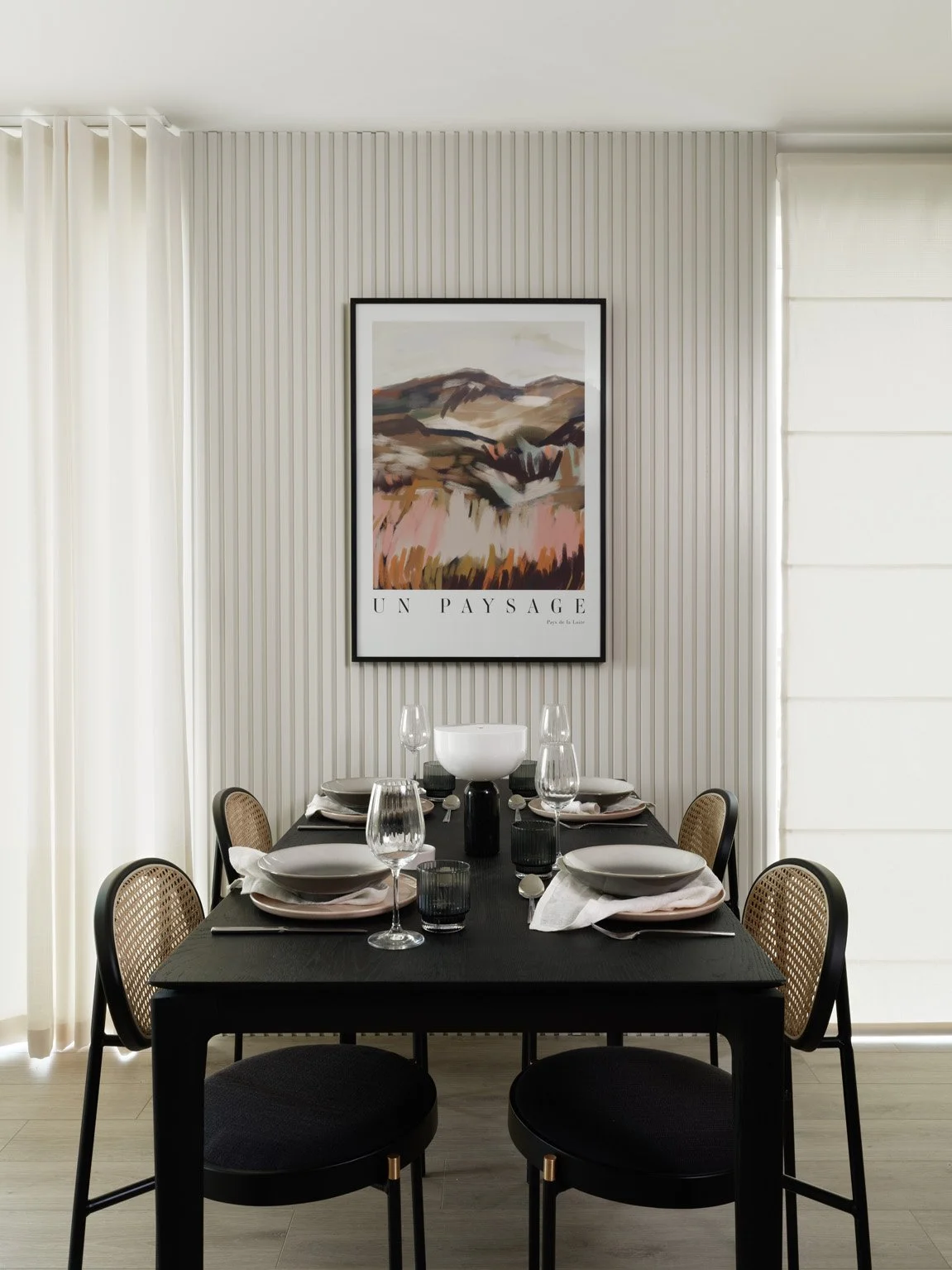 cream dining with blinds closed and artwork over table
