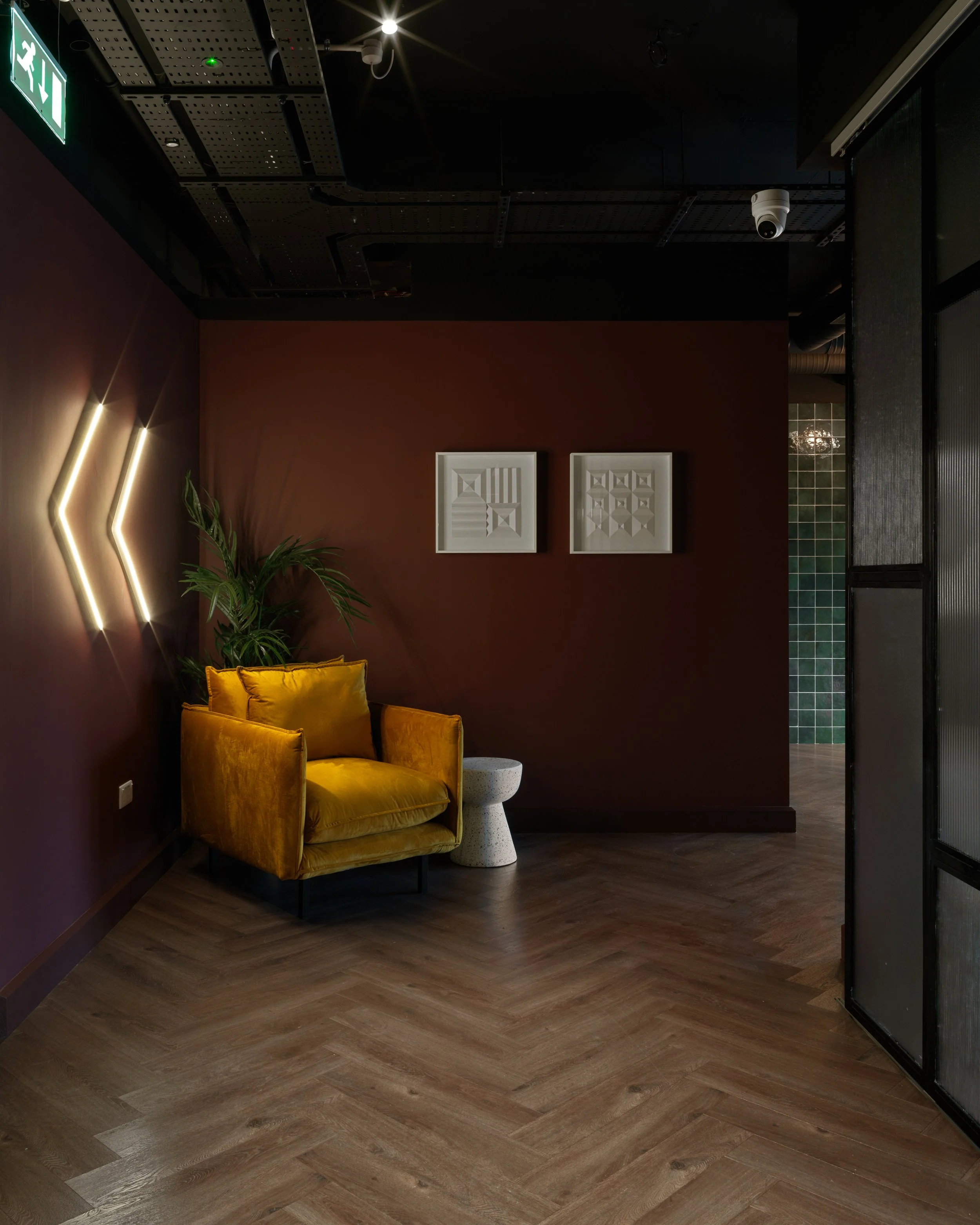 neon arrow sign with yellow armchair 