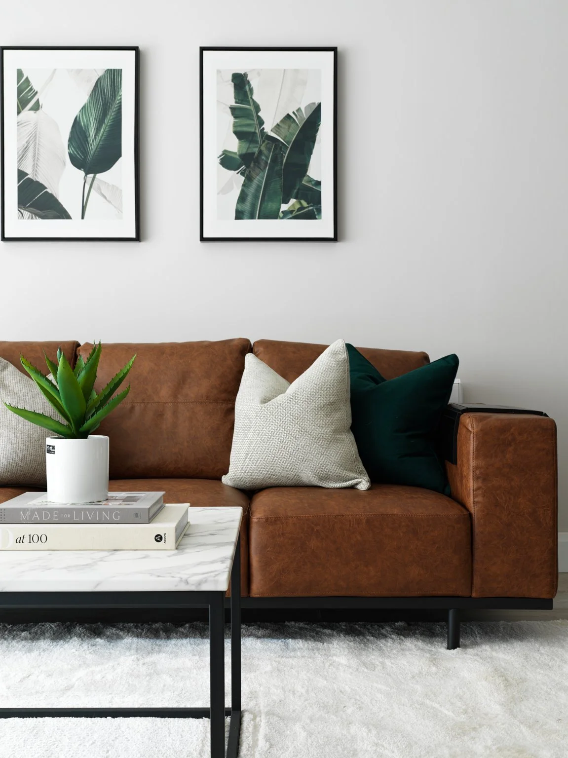 brown leather couch in bright contemporary apartment