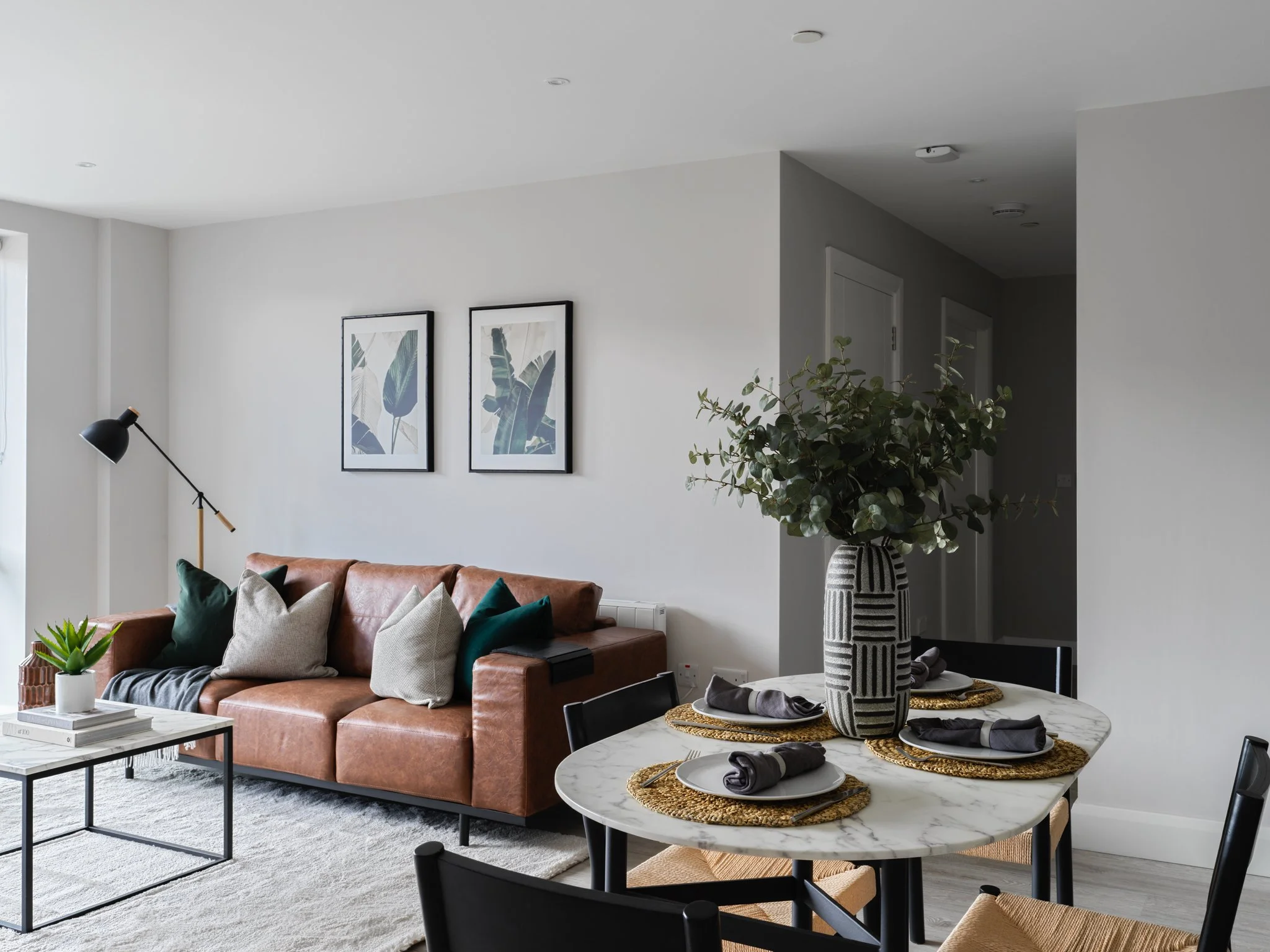 open plan living dining area with brown leather sofa