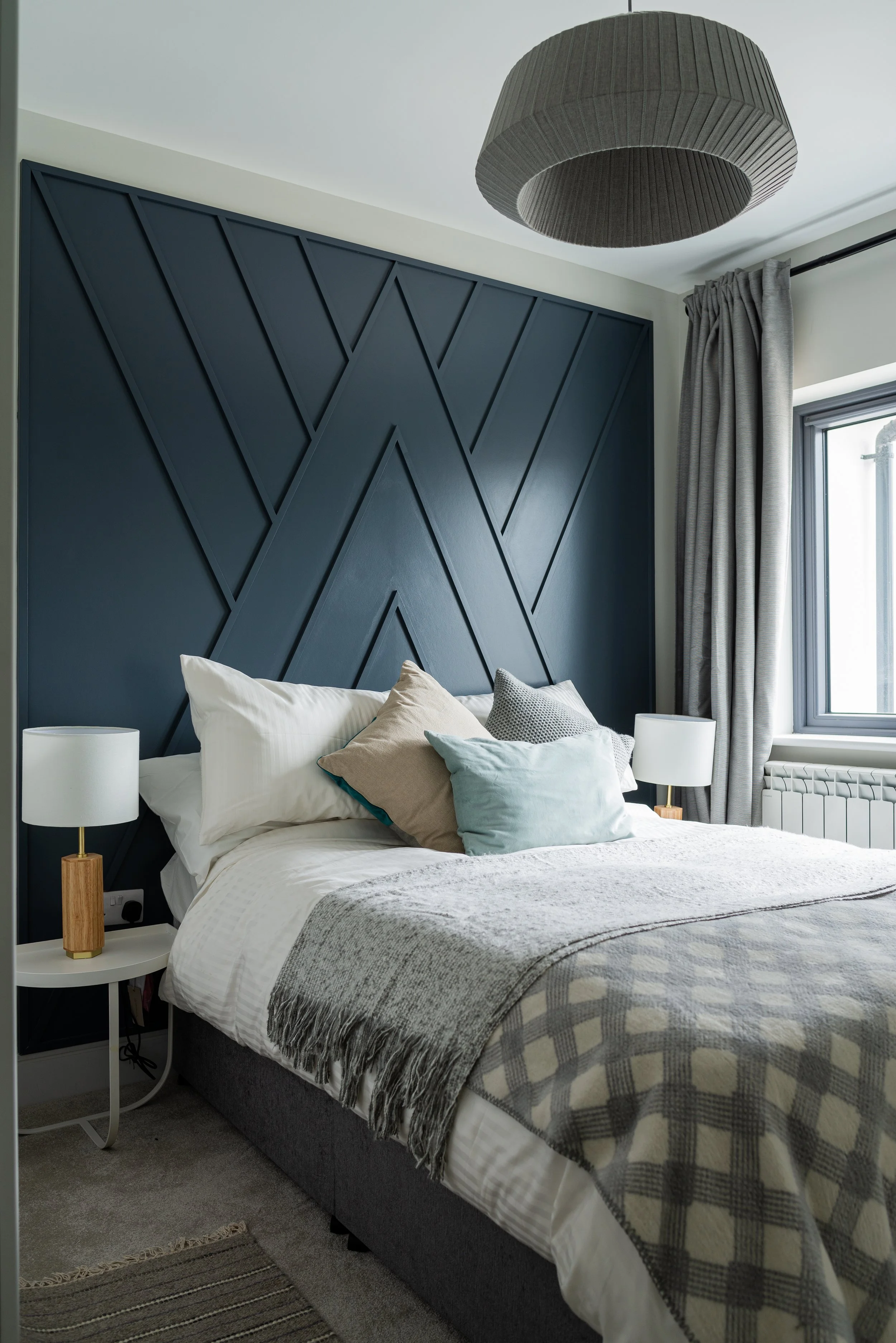 double room with large navy custom headboard 