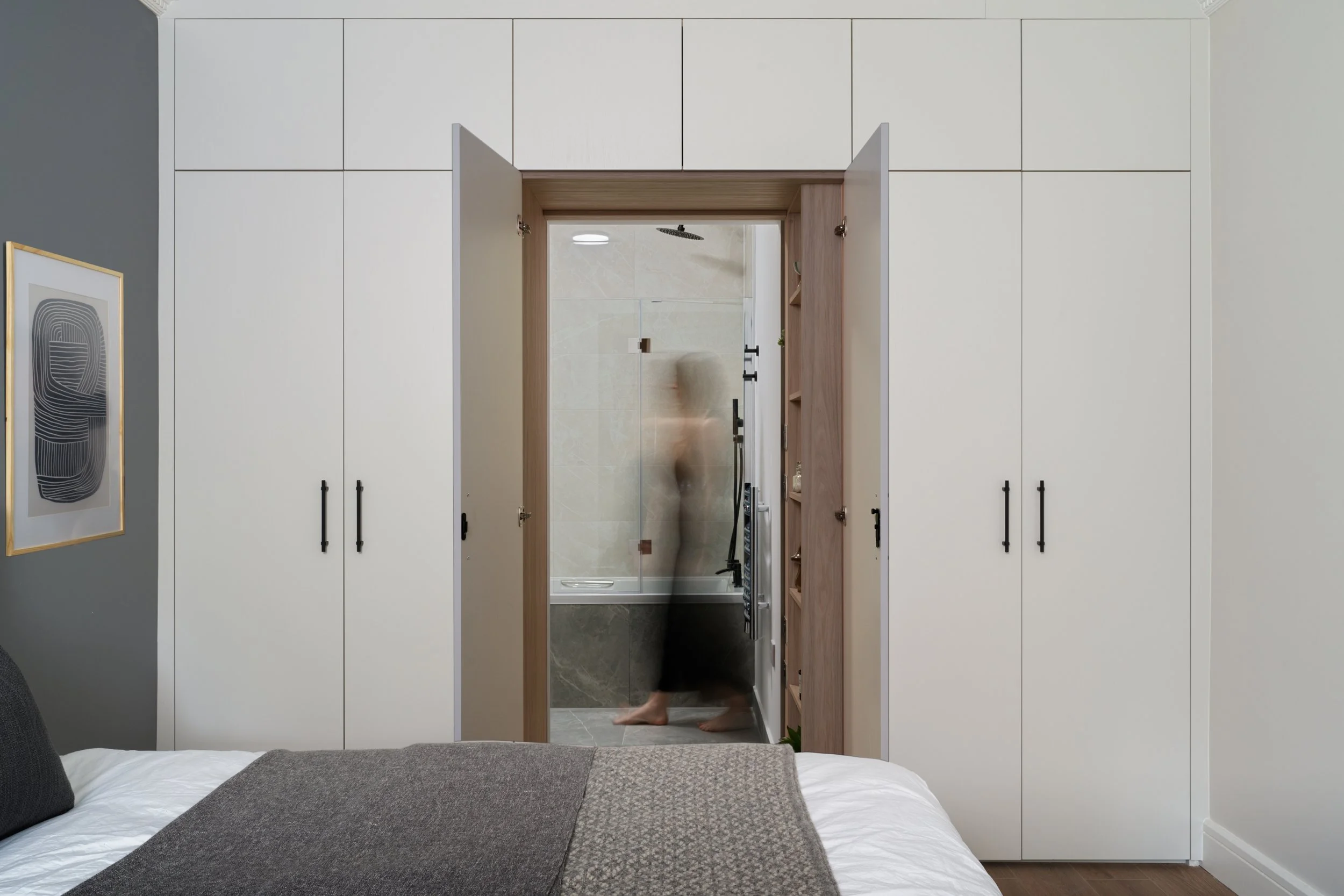 beige in-built bedroom cabinetry and hidden en-suite bathroom