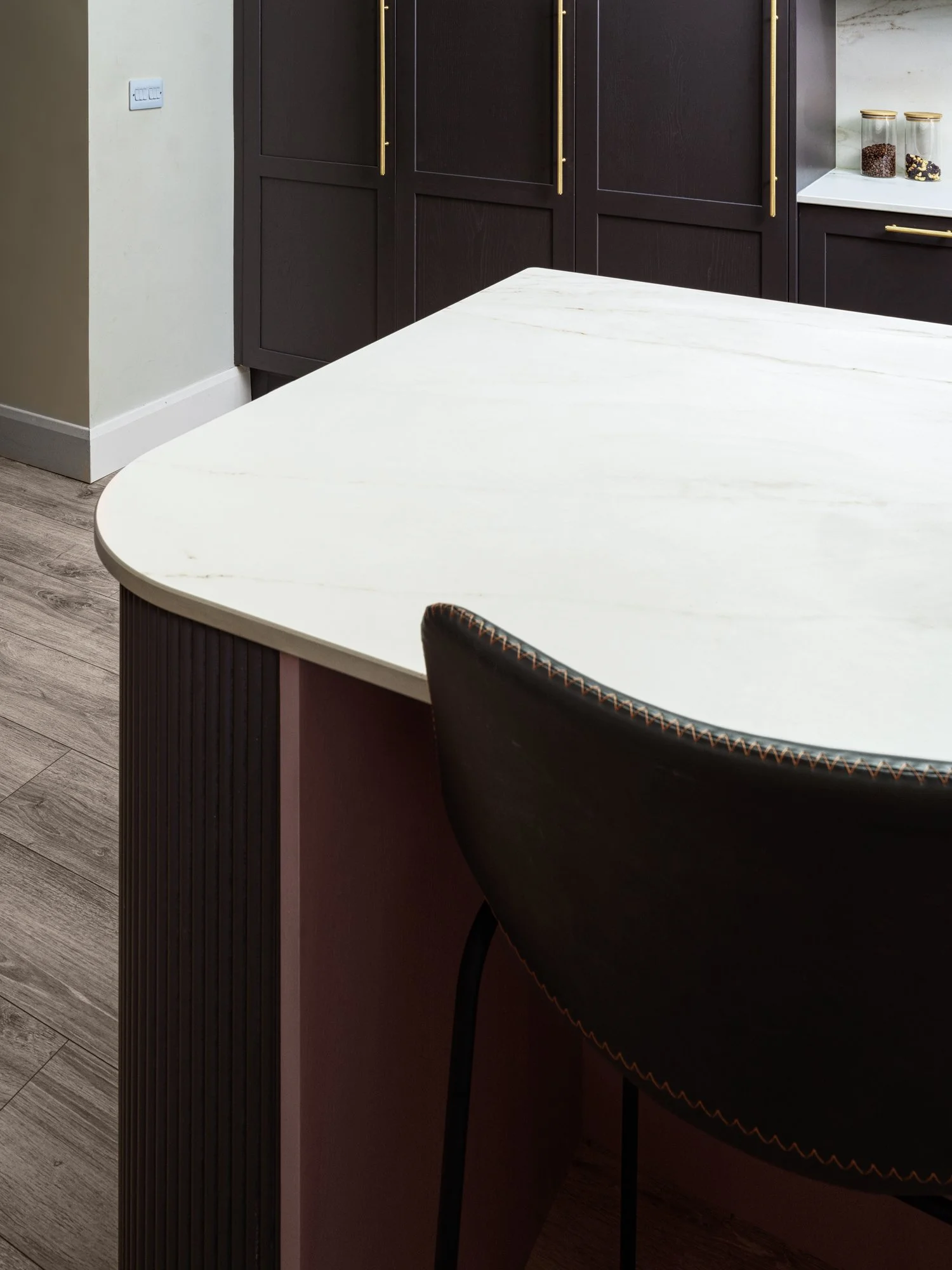 curved kitchen island with marble countertop
