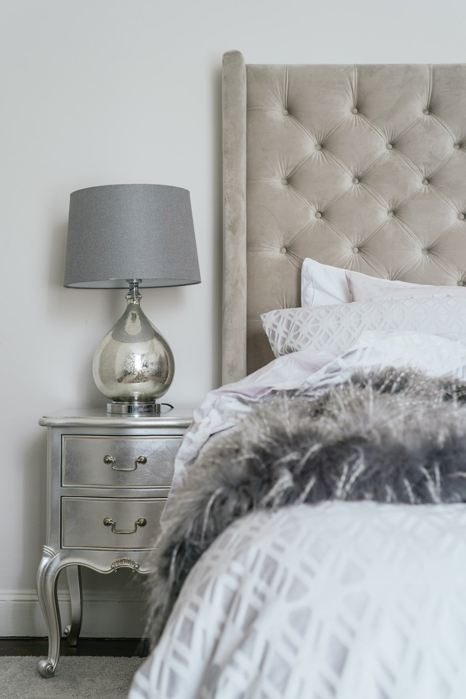 silver beside table with silver lamp and headboard