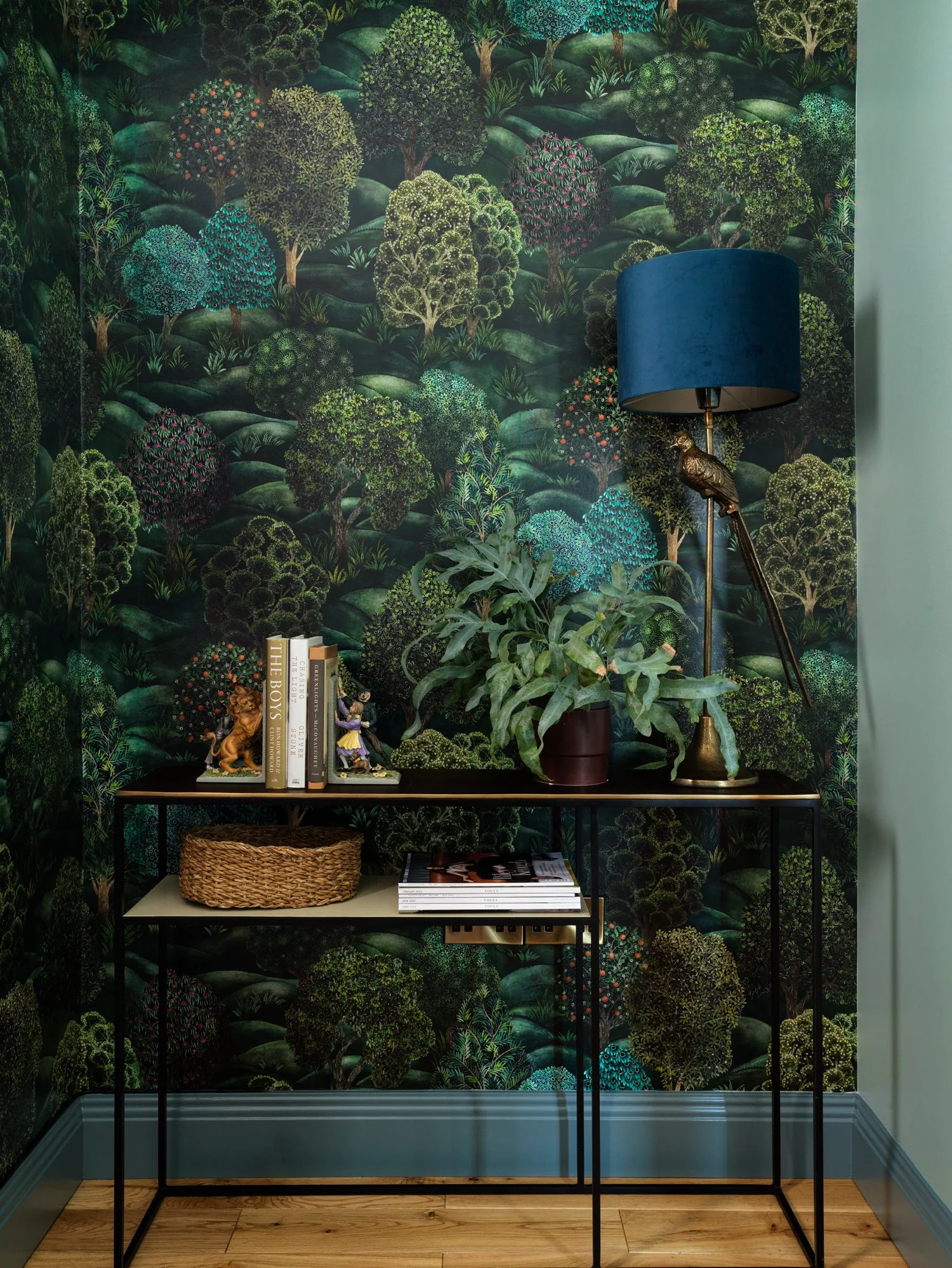 dark green wallpaper with organic pattern behind table interior design