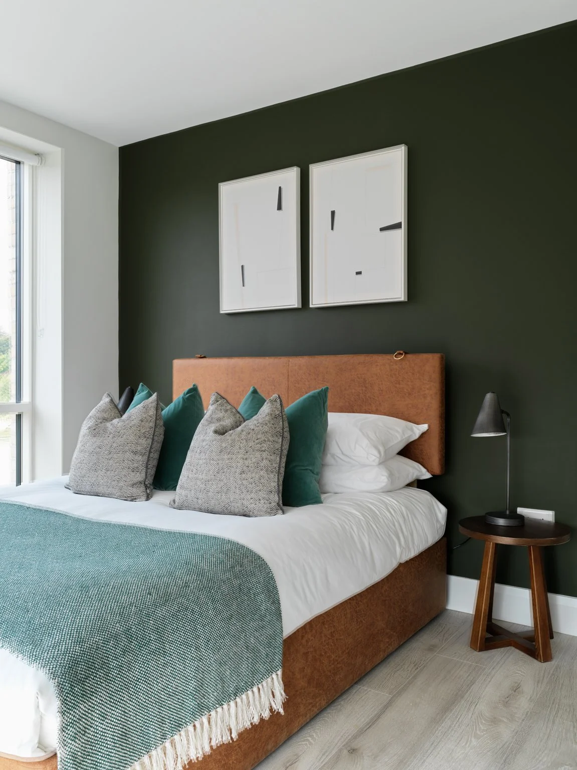 brown divan bed with moss green walls