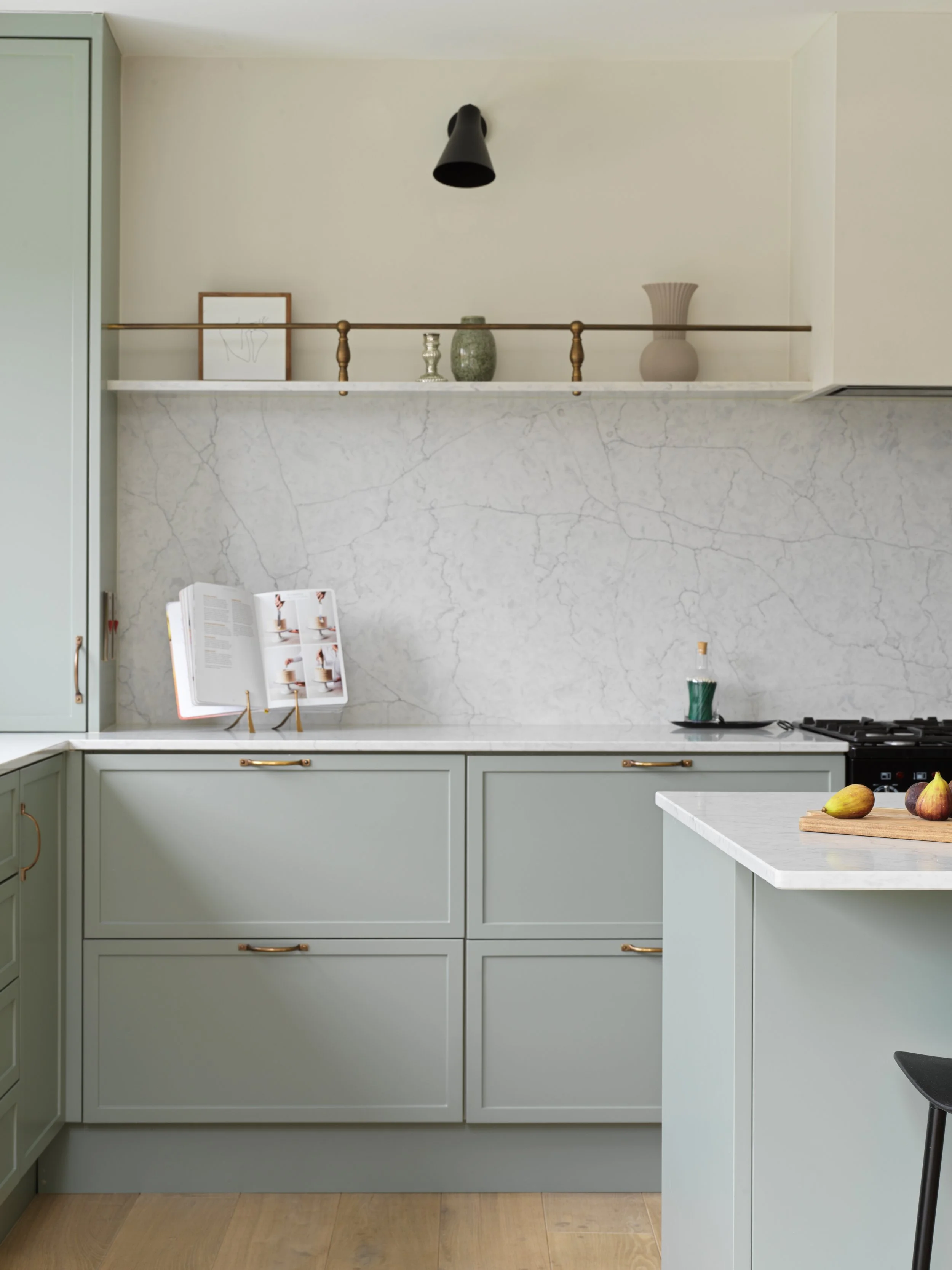sage green kitchen detail with open cook book