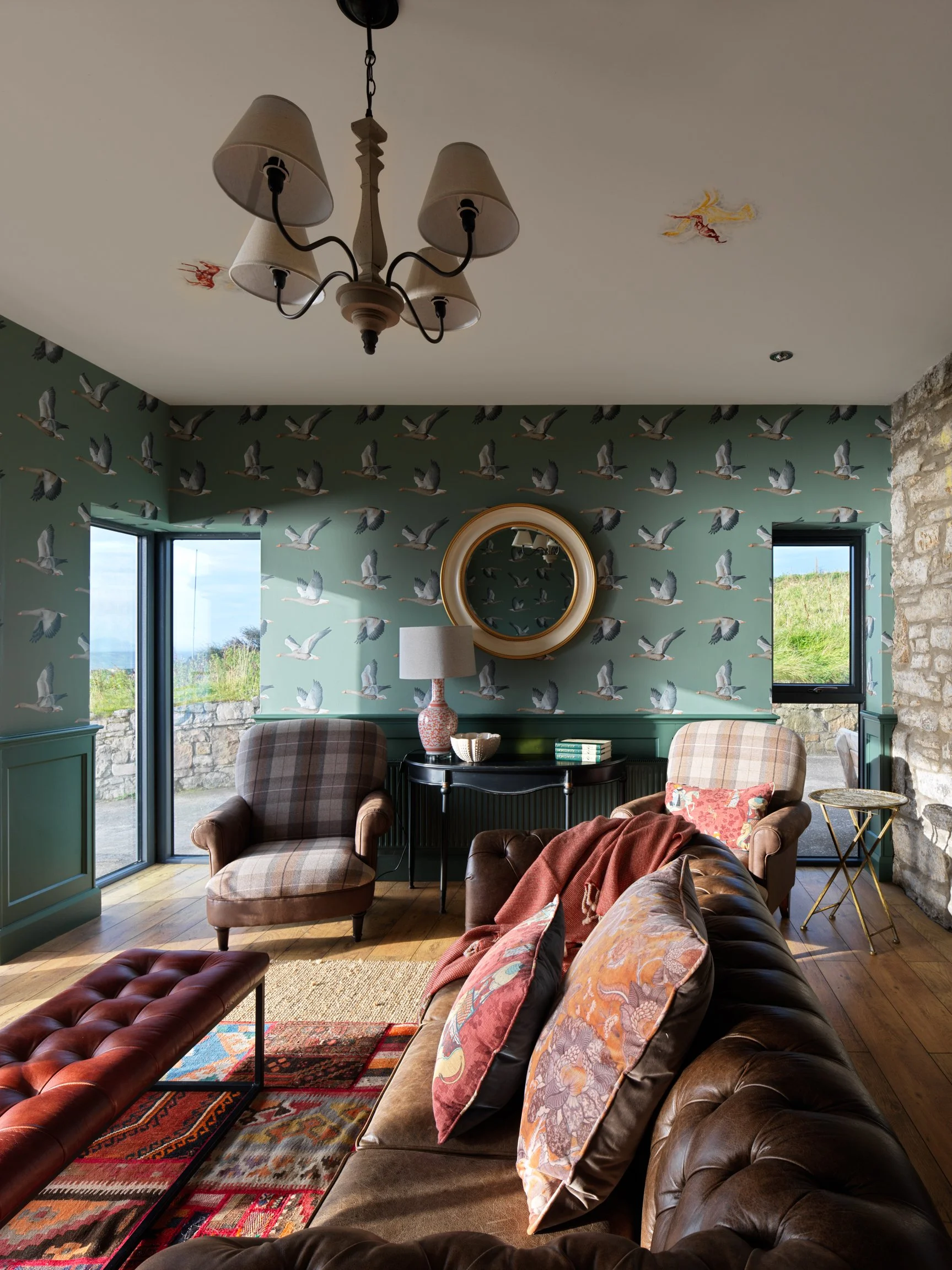 leather sofa with bird wall paper and morning sunlight