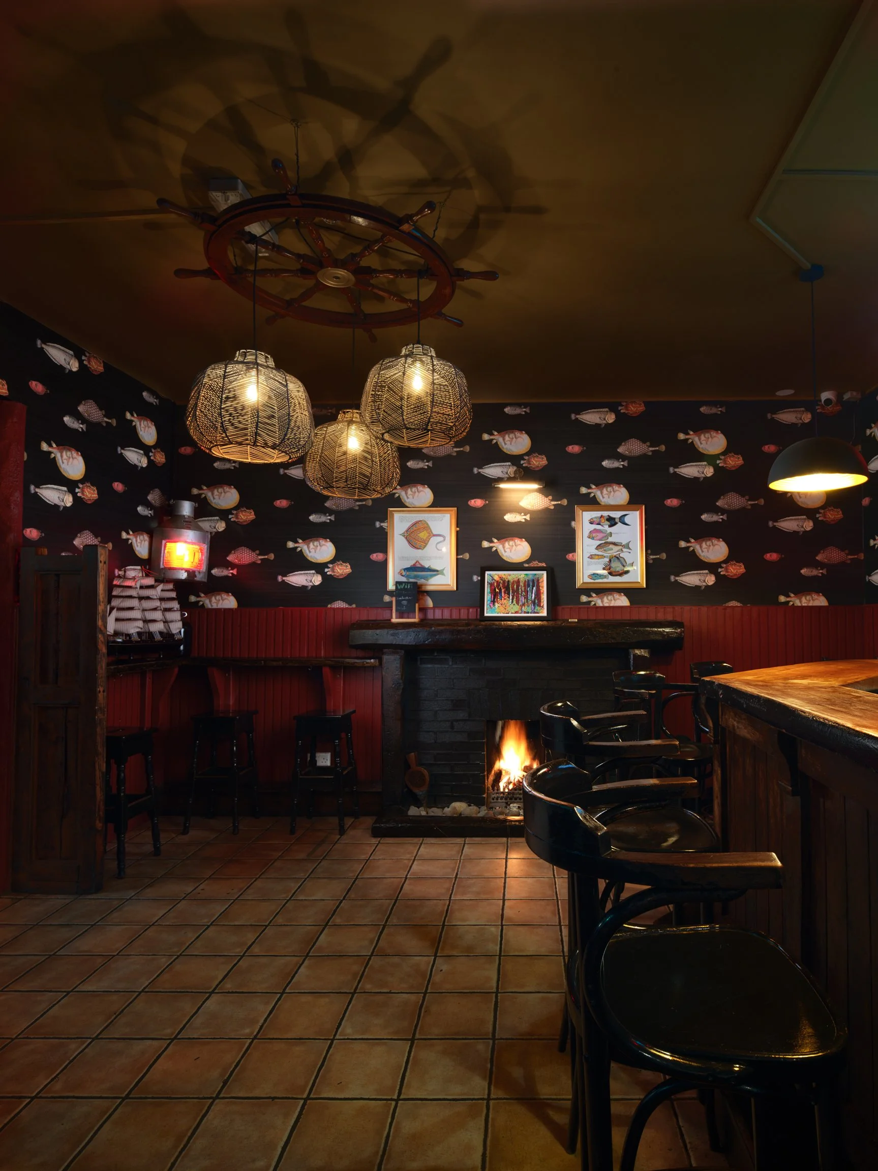 old Irish bar with fire lit and large ships wheel as ceiling light