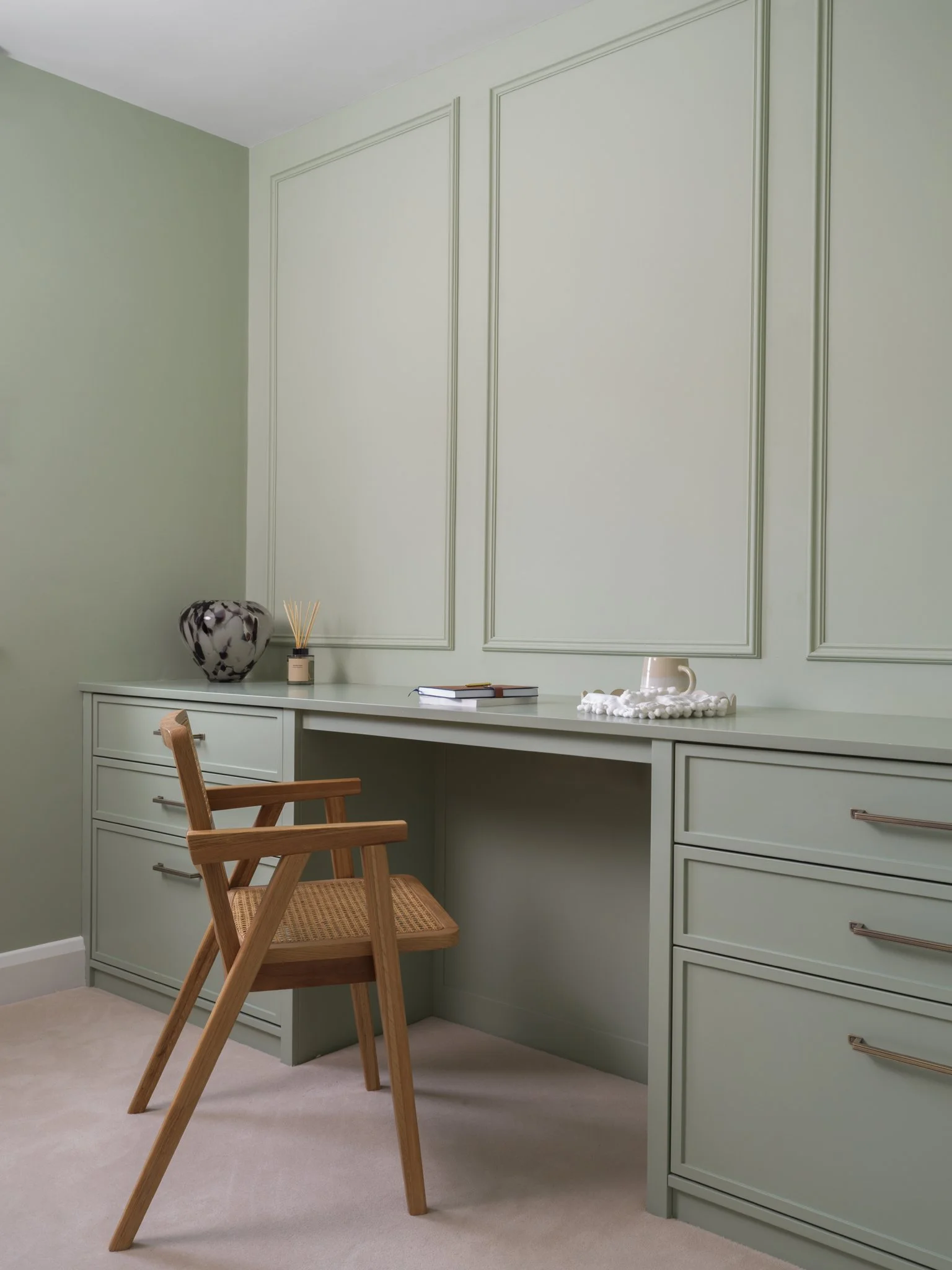 sage green office with sage desk and brown chair