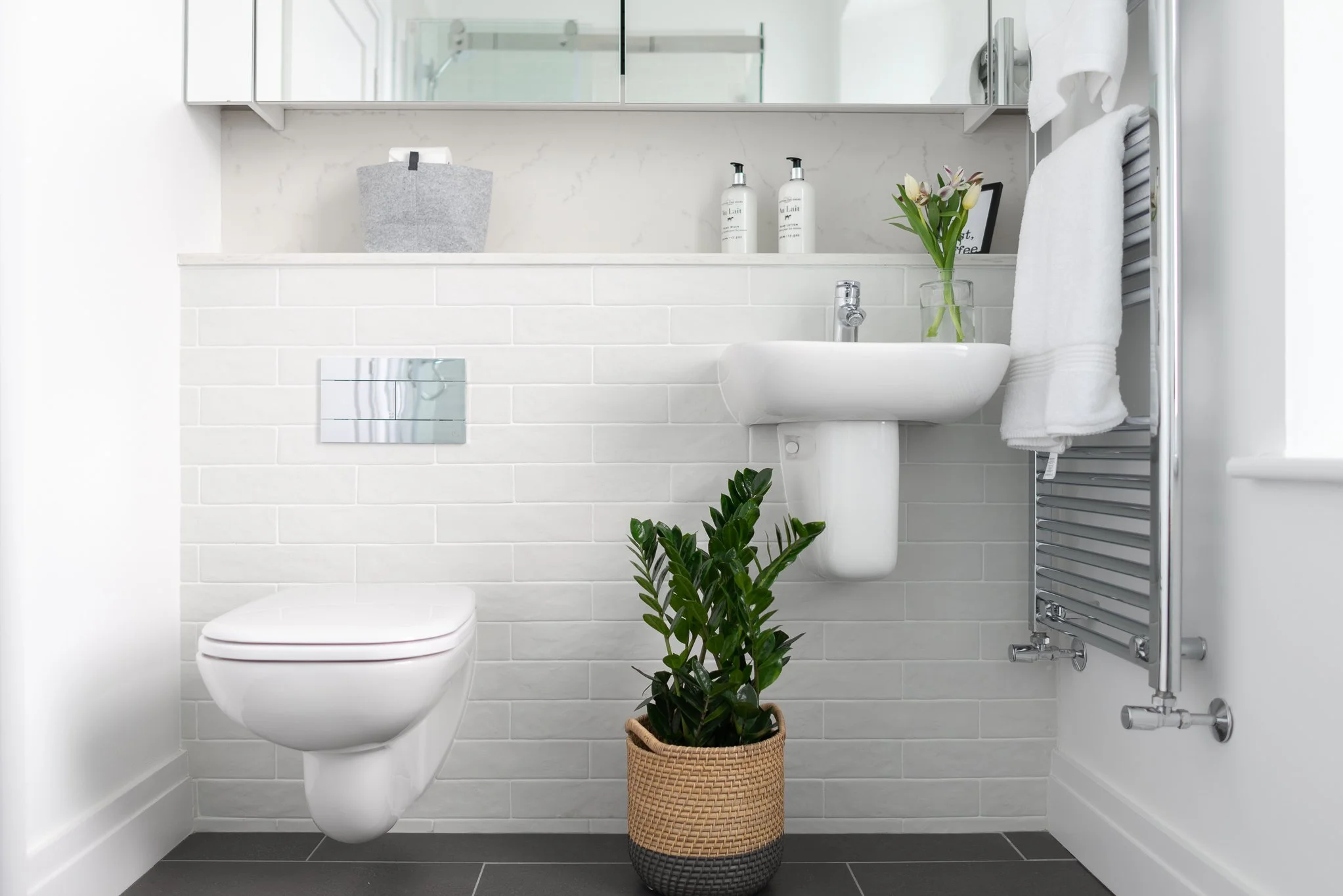 white bathroom with rattan flower basket