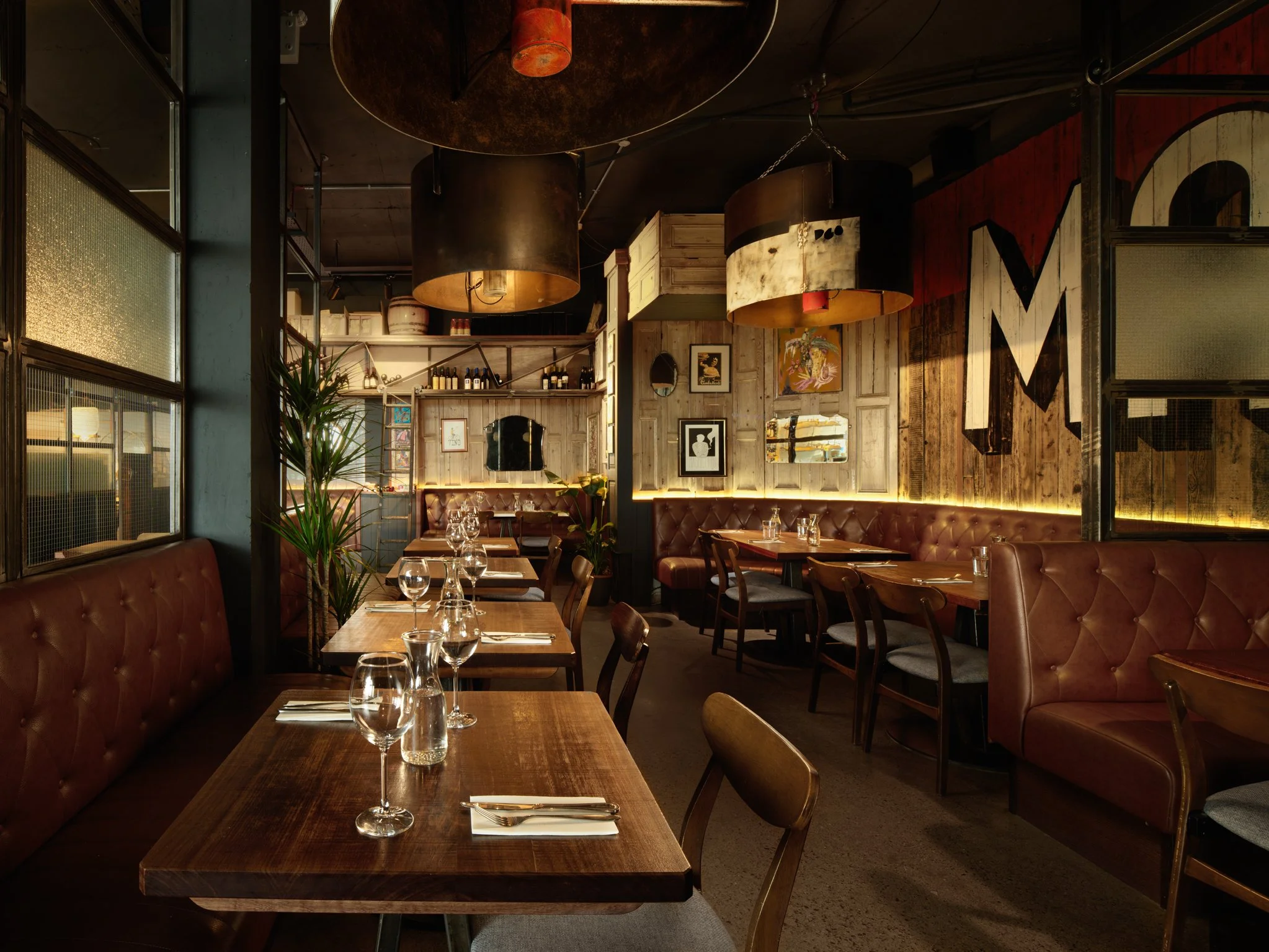 Dining area with industrial-designed large steel lampshades in Magnetti's, Salthill, Co. Galway